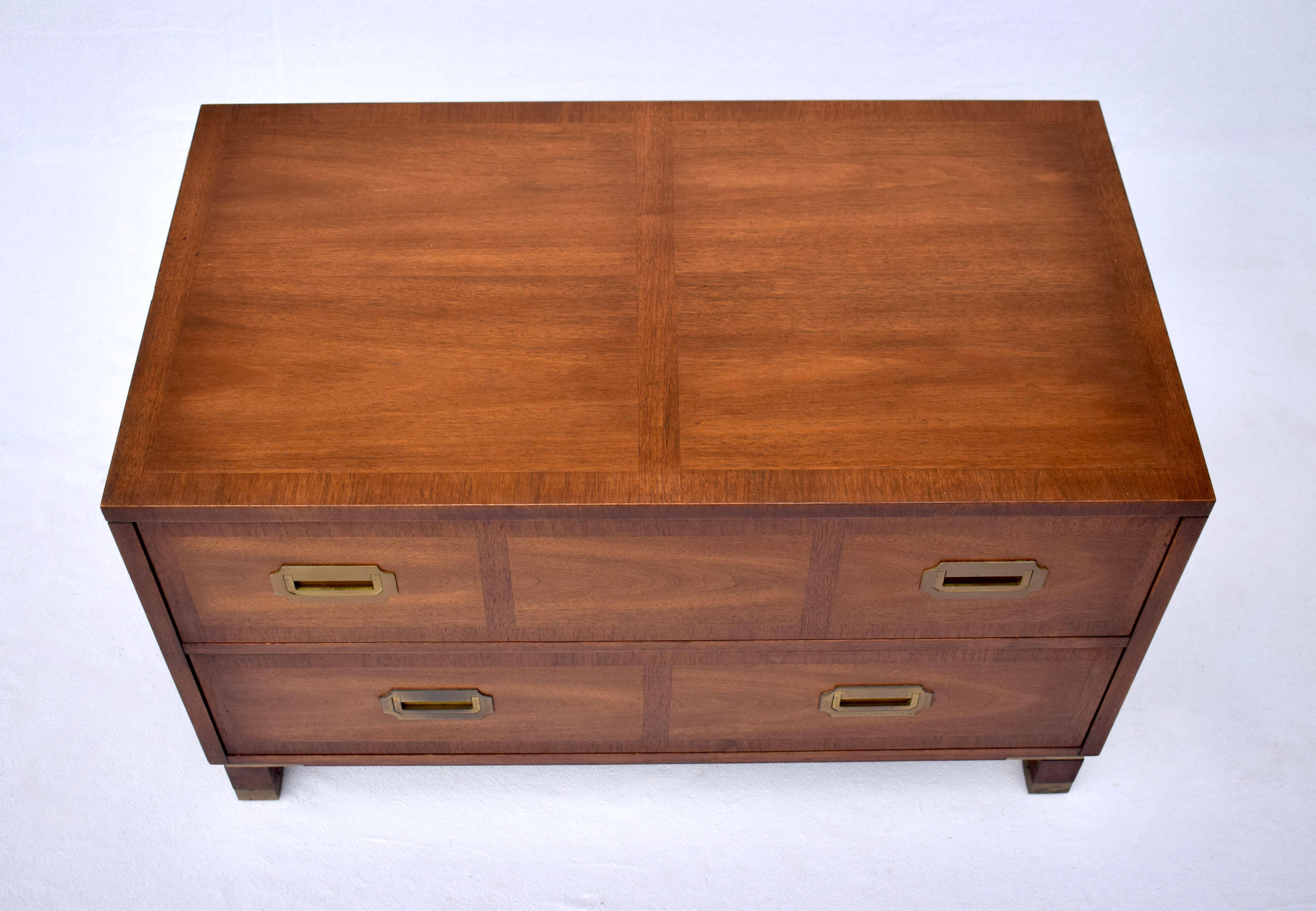 Baker Campaign style chest of two generously sized drawers with handsome banded walnut top & front. Original brass hardware enhances striking walnut grains. Nice multifunctional storage  suitable in a wide variety of settings.