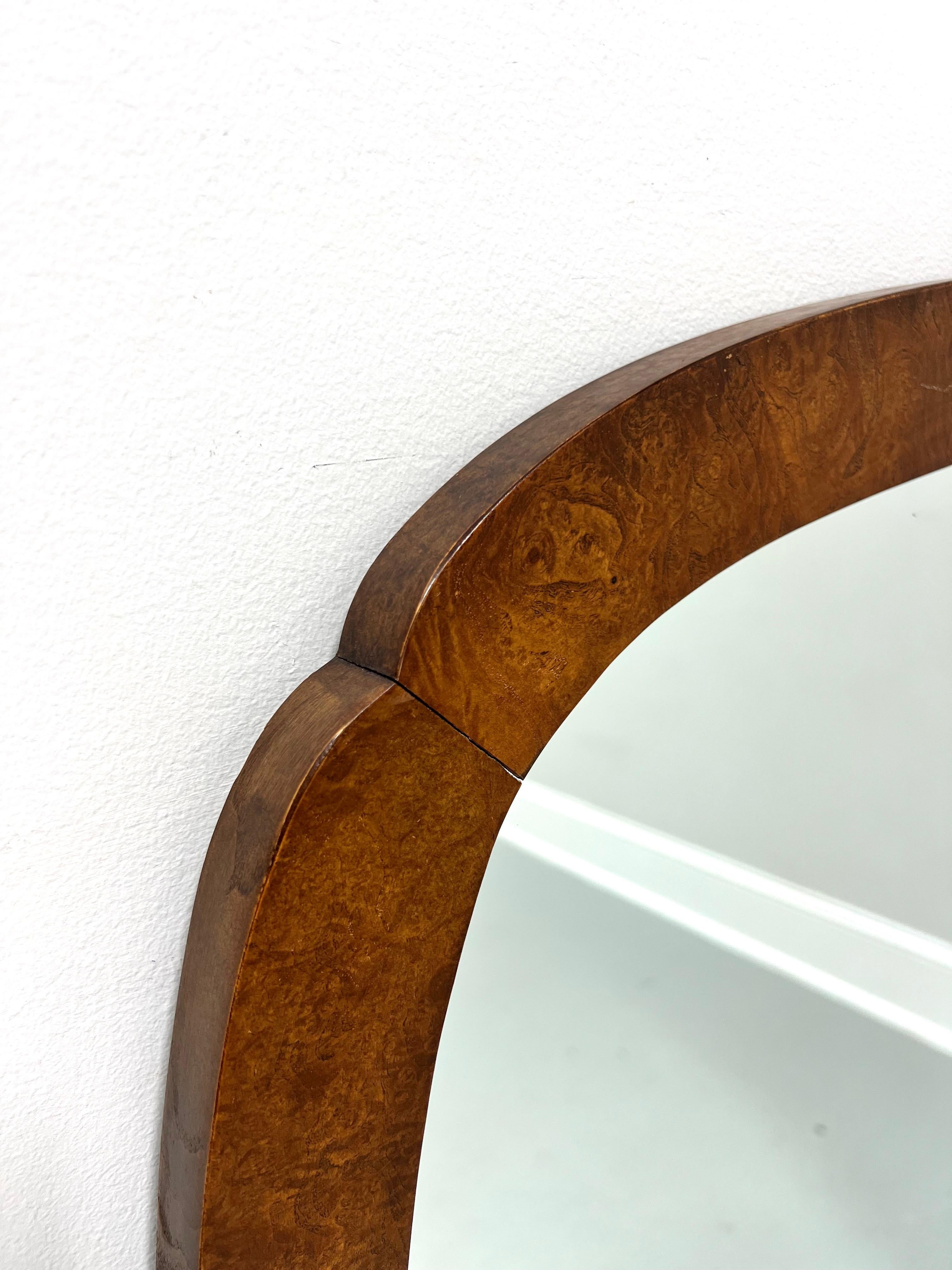 An Asian inspired dresser or wall mirror by Baker Furniture. Mirror glass in a burl walnut frame with rounded clipped corners. Made in North Carolina, USA, in the late 20th Century. 

Measures: 33.5w 1.5d 47.5h, Weighs Approximately: 38