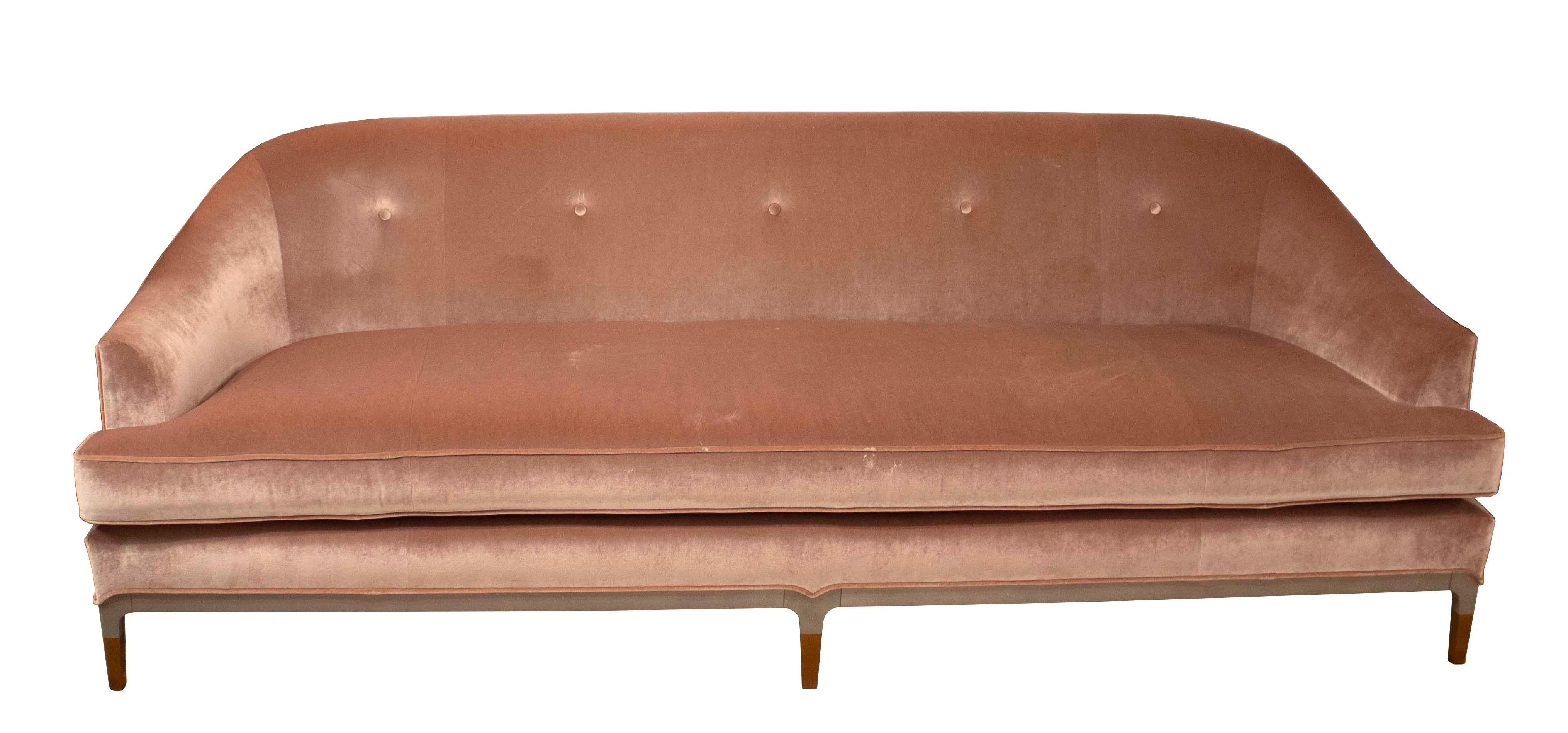 This 3-seat sofa was designed by Jean-Louis Denoit for Baker and is upholstered in a sophisticated blush velvet with the legs and frame in both a nougat wood and an antique bronze finish. The curved back and attention to detail makes this vintage