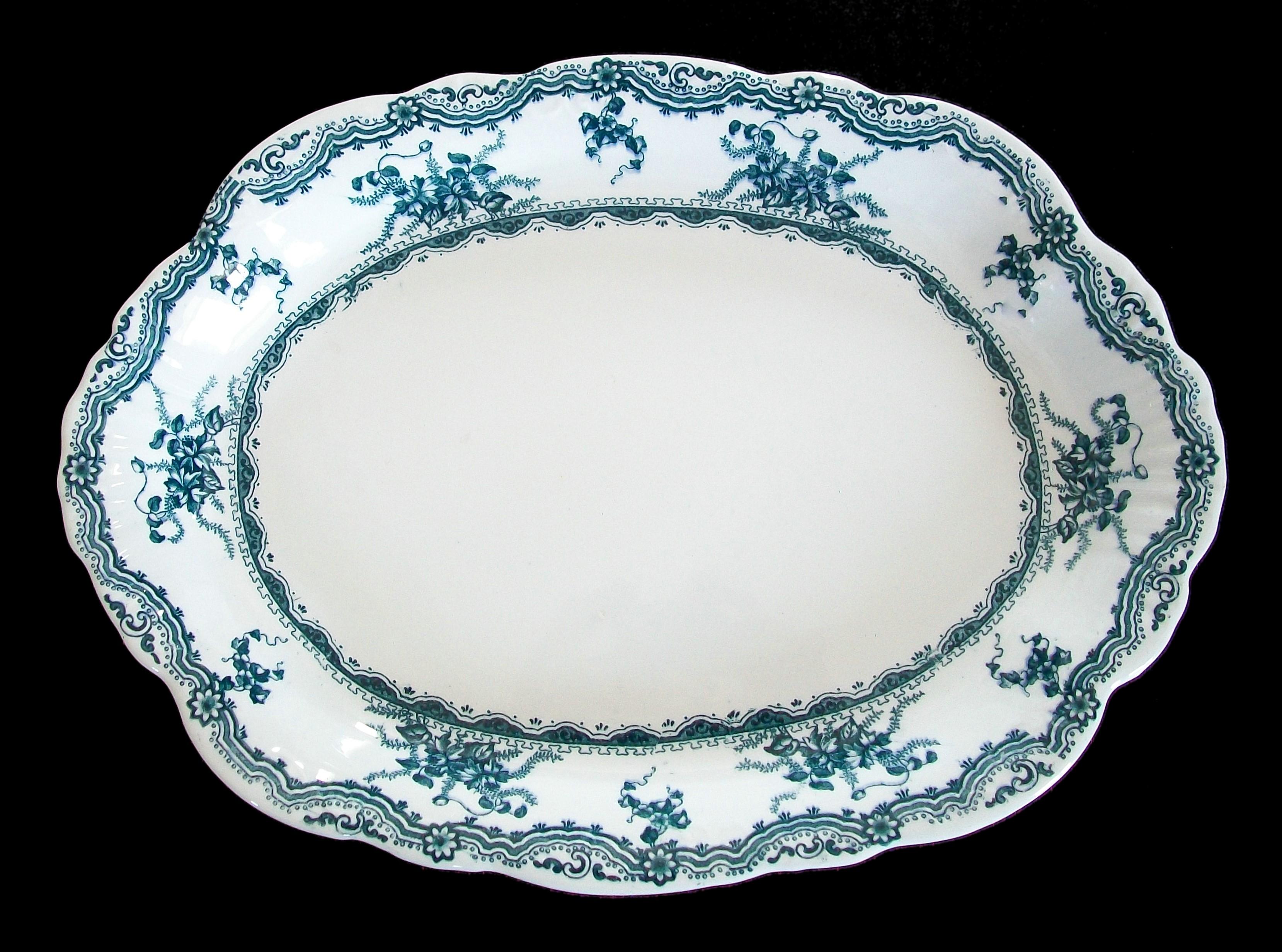 BAKER & CO. LTD. - Antique ceramic serving platter - large size - transfer decorated in blue/green on a cream ground - undecorated center - signed on the base - United Kingdom (Staffordshire) - circa 1893.

Excellent/near mint antique condition -