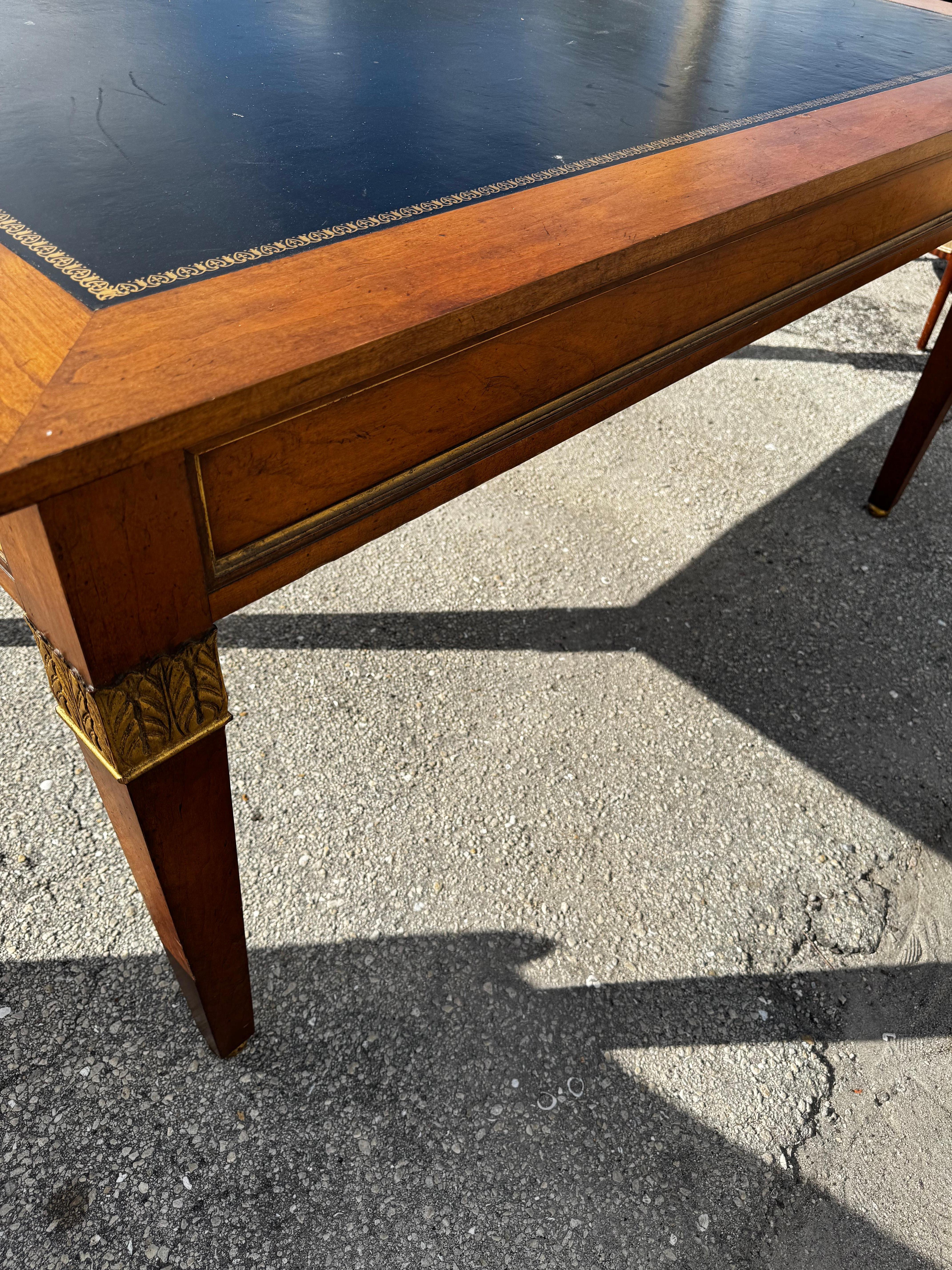 This exquisite Baker Furniture desk combines vintage charm with timeless elegance, making it a standout piece for any office or study. Crafted in the United States by skilled artisans, this large writing desk features a luxurious leather top that