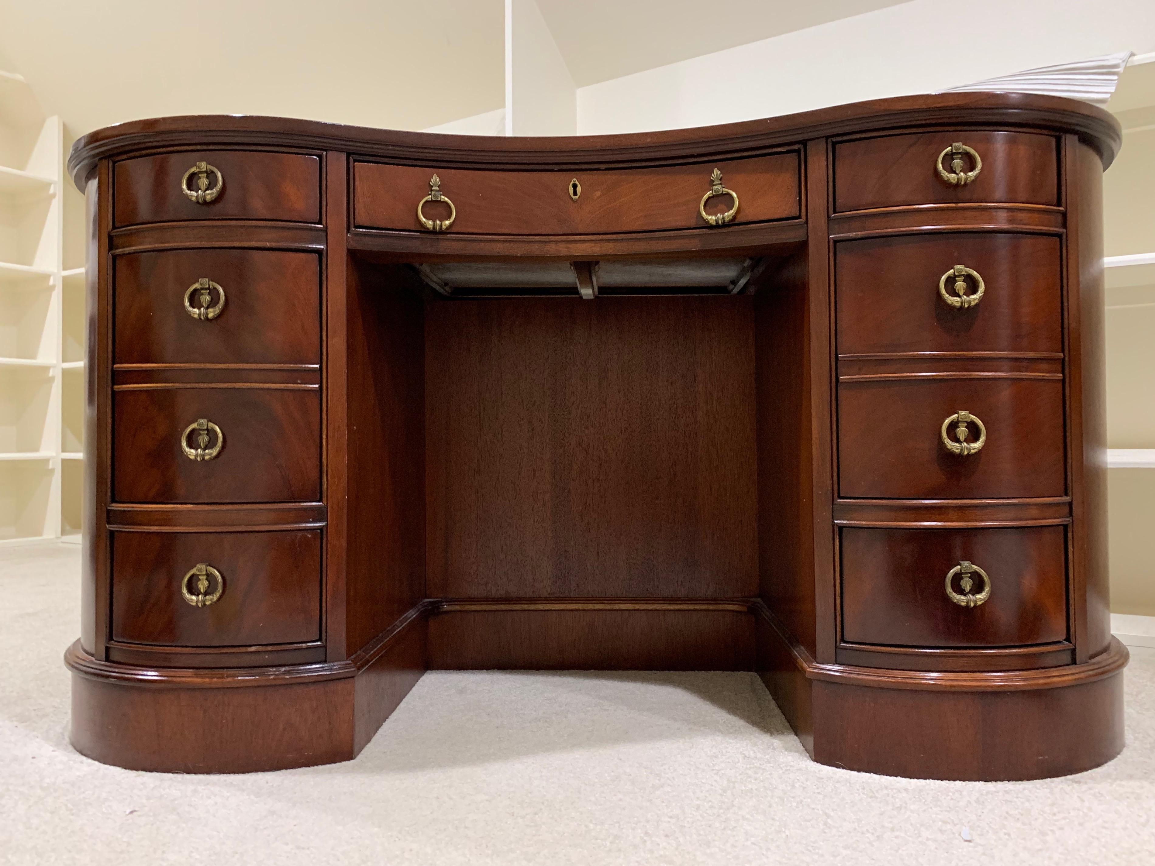 Gorgeous crescent shaped desk made by Baker Furniture. Lockable top drawer with original key. Leather top. Classic design. Priced to sell right away.