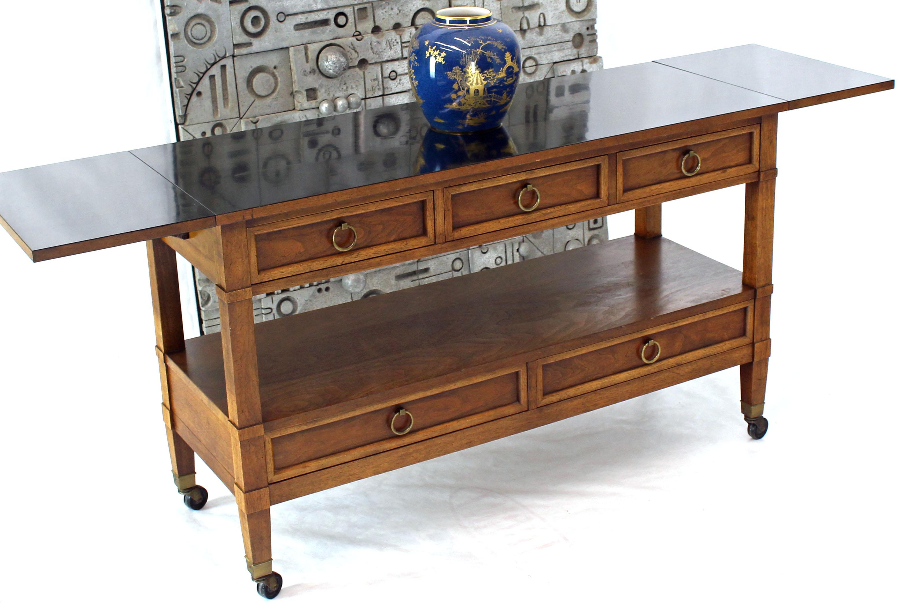 Mid-Century Modern large serving table cart with round brass pulls by Baker. Black laminate top, 12