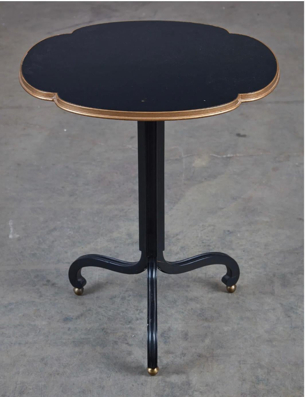 This exquisite Baker table is a testament to fine craftsmanship and timeless elegance. Expertly constructed, the piece features a rich ebonized wood finish, beautifully contrasted by gilt-heightened detailing, adding a touch of neoclassical