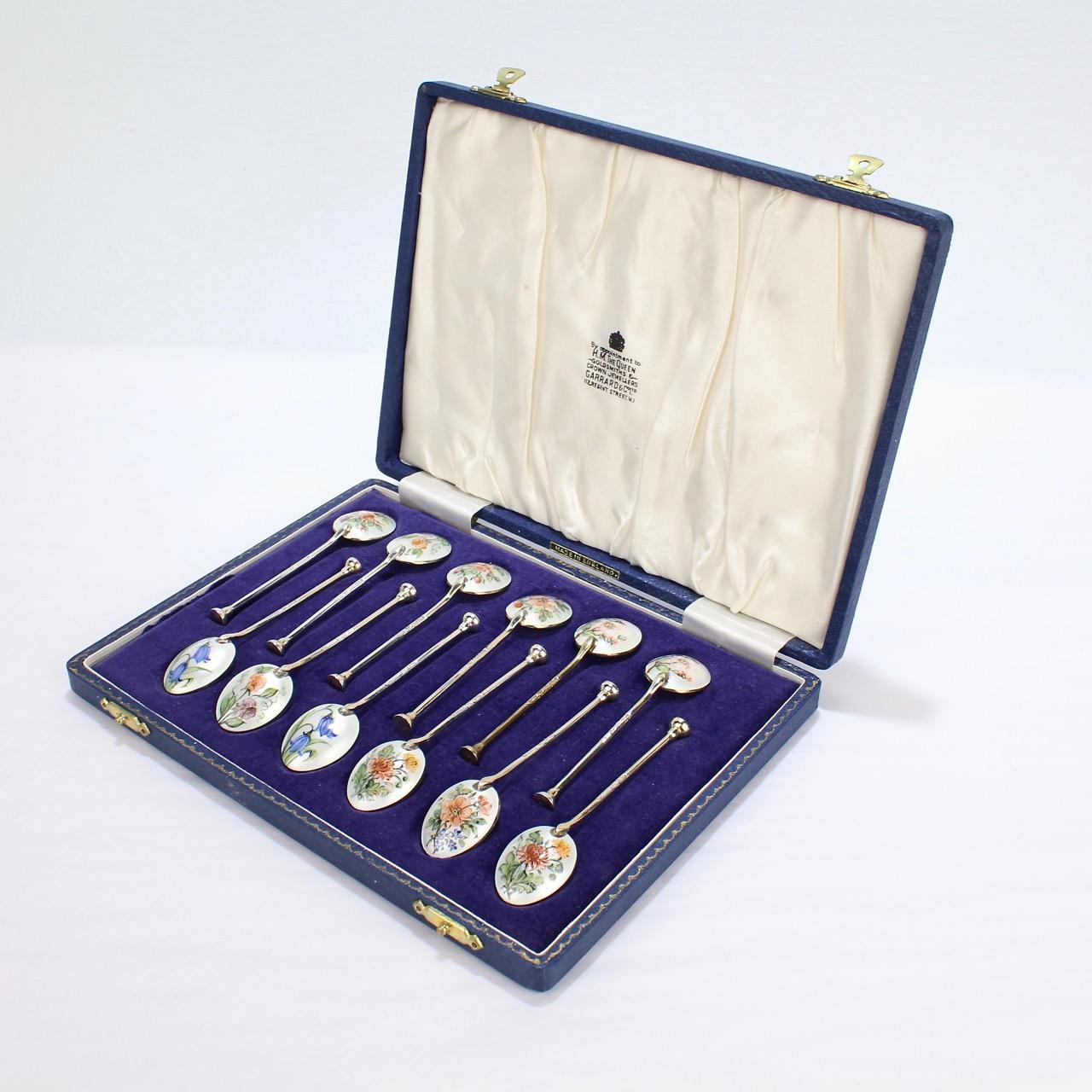 A fine complete boxed set of 12 botanical enameled silver demitasse spoons.

The reverse of each enameled and decorated with various flower species.

Each marked England and hallmarked for Baker Ellis Silver Co., Birmingham, Sterling, and