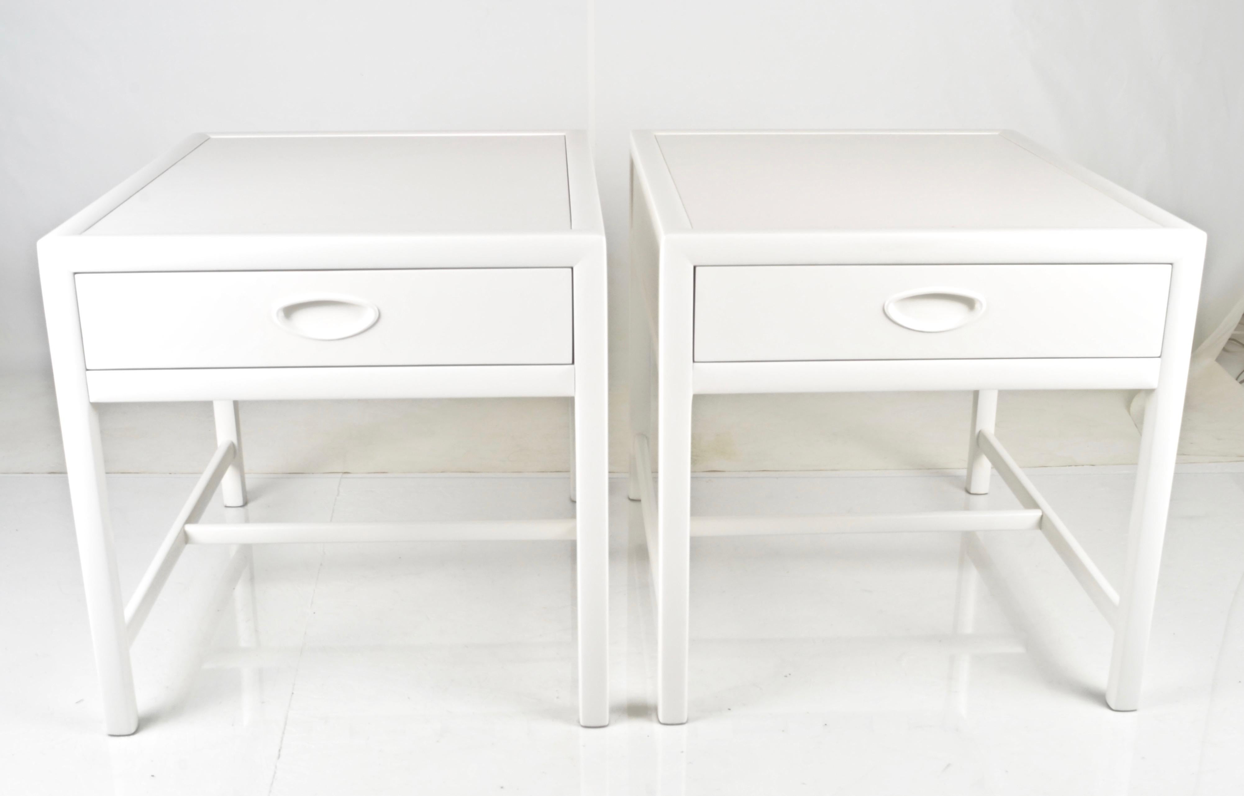 Classic modern single-drawer end tables or bedside tables made by Baker Furniture in the 1950s. Now restored with a new satin lacquer finish in dove white. Note: back is fully finished allowing tables to be floated if desired. Quality construction.