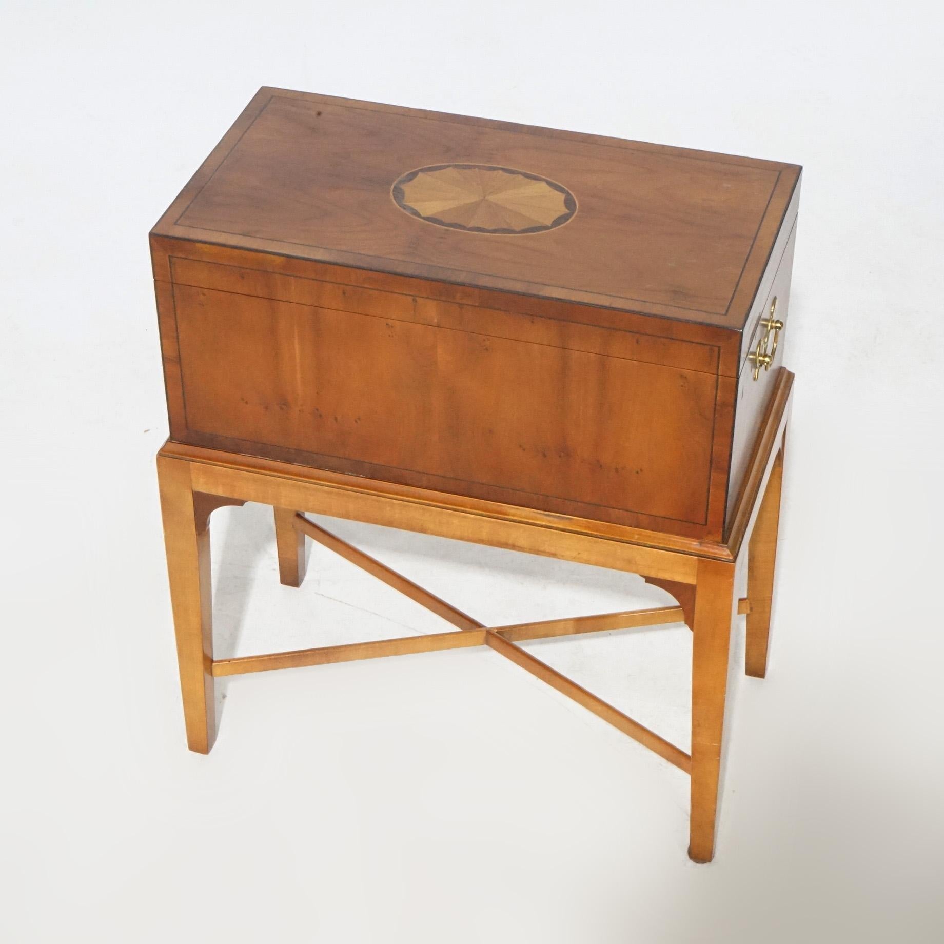 An English Hepplewhite style cellarette by Baker offers kingwood construction with satinwood inlay, raised on straight and tapered legs, maker label as photographed, 20th century

Measures - 23