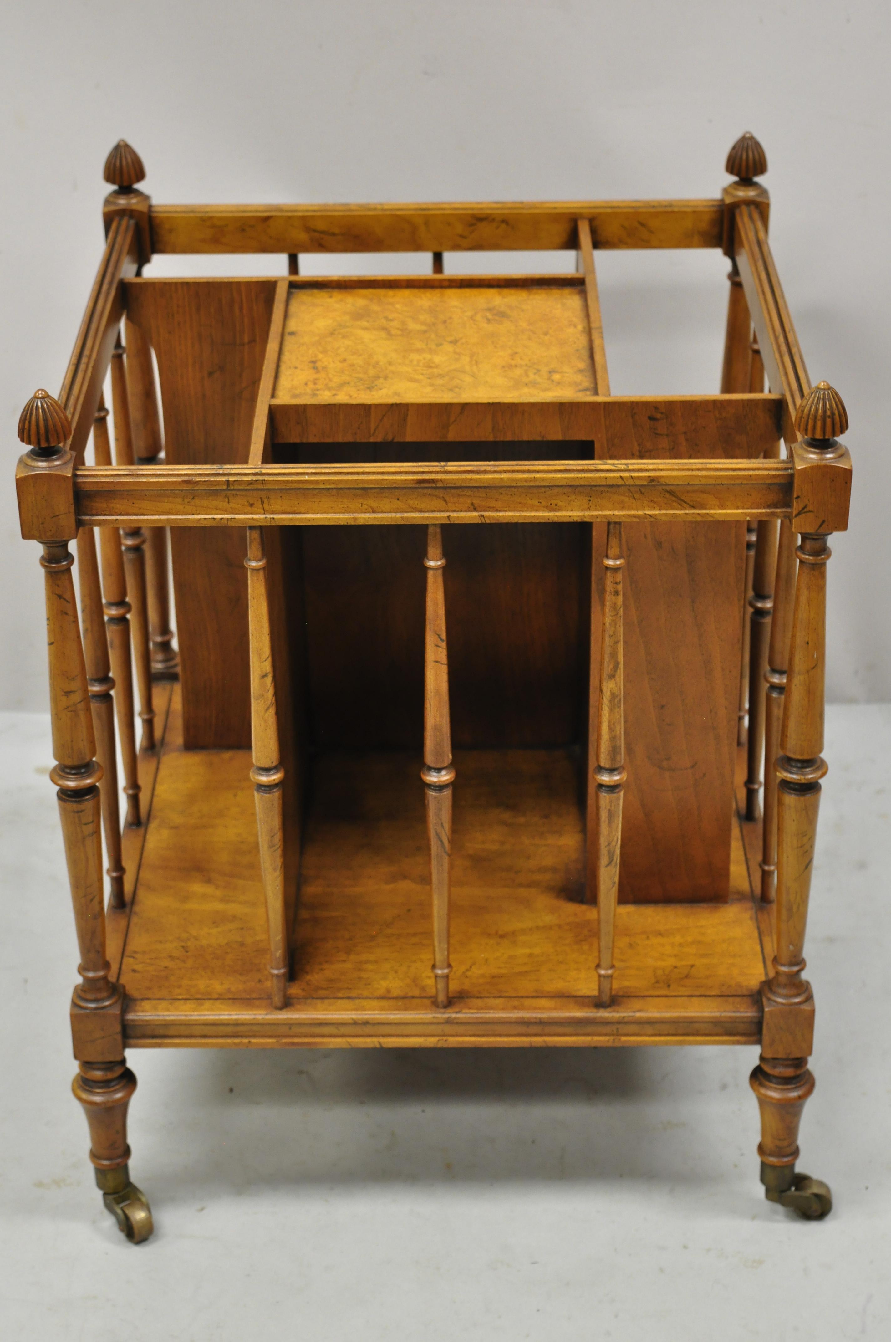 Baker English Regency burl wood canterbury magazine rack stand on wheels. Item features brass rolling casters, beautiful wood grain, original stamp, quality American craftsmanship, great style and form. Circa Mid 20th Century. Measurements: 23