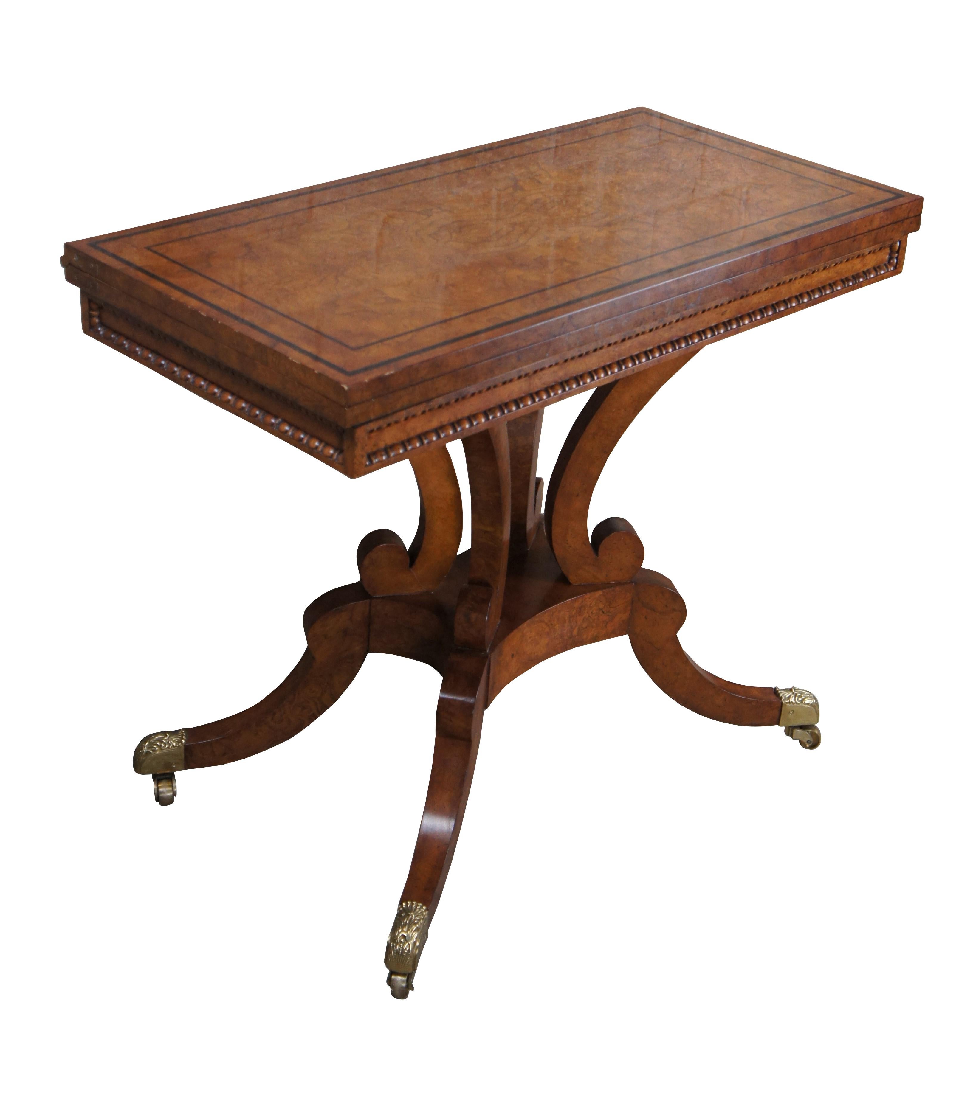 An exceptional English Regency / Georgian inspired Flip top game table or console by Baker Furniture. The design is after the Original made by William Trotter of Edinburgh in 1815. 

The rectangular fold over top has a beaded moulded edge, and