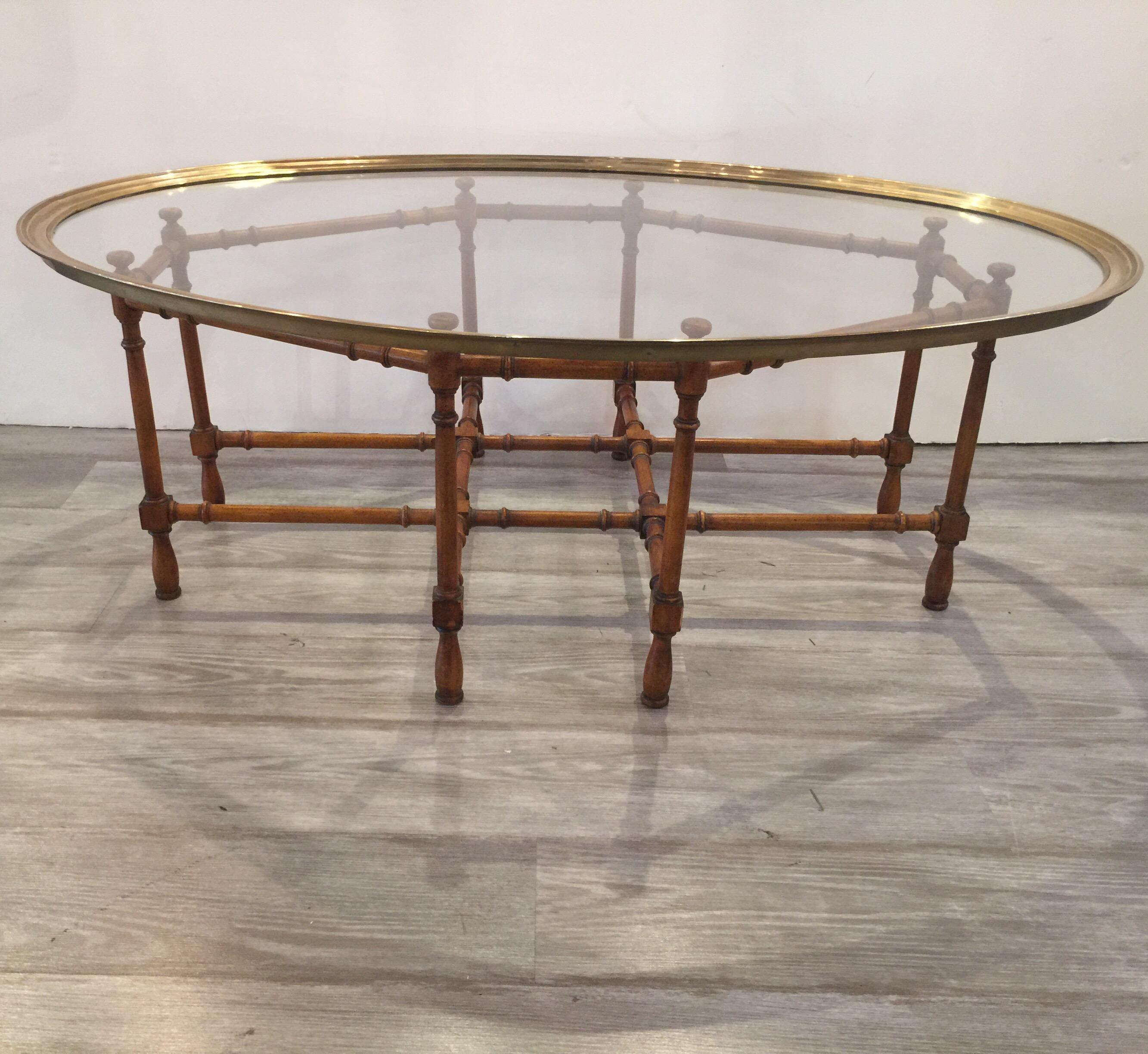 Baker faux bamboo cocktail/coffee table with brass and glass top from the 1970s
Nice table with a removable top for easy moving and cleaning 
Dimensions: 31.5