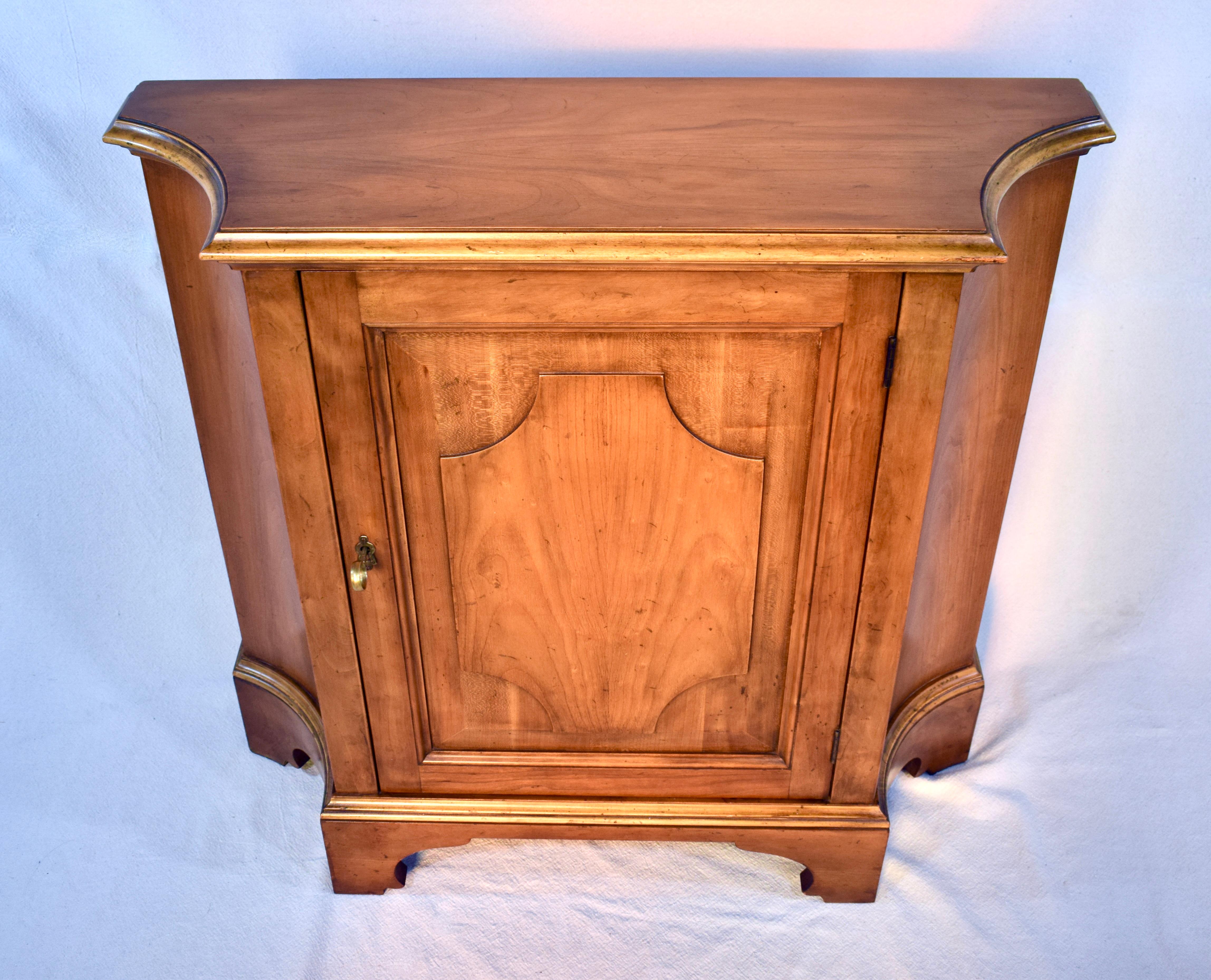 A versatile console cabinet or commode by Baker Furniture, circa 1960s of French cherry wood with a single raised panel door and one shelf. Features working lock & original brass key. We love everything about this cabinet including its' versatility.
