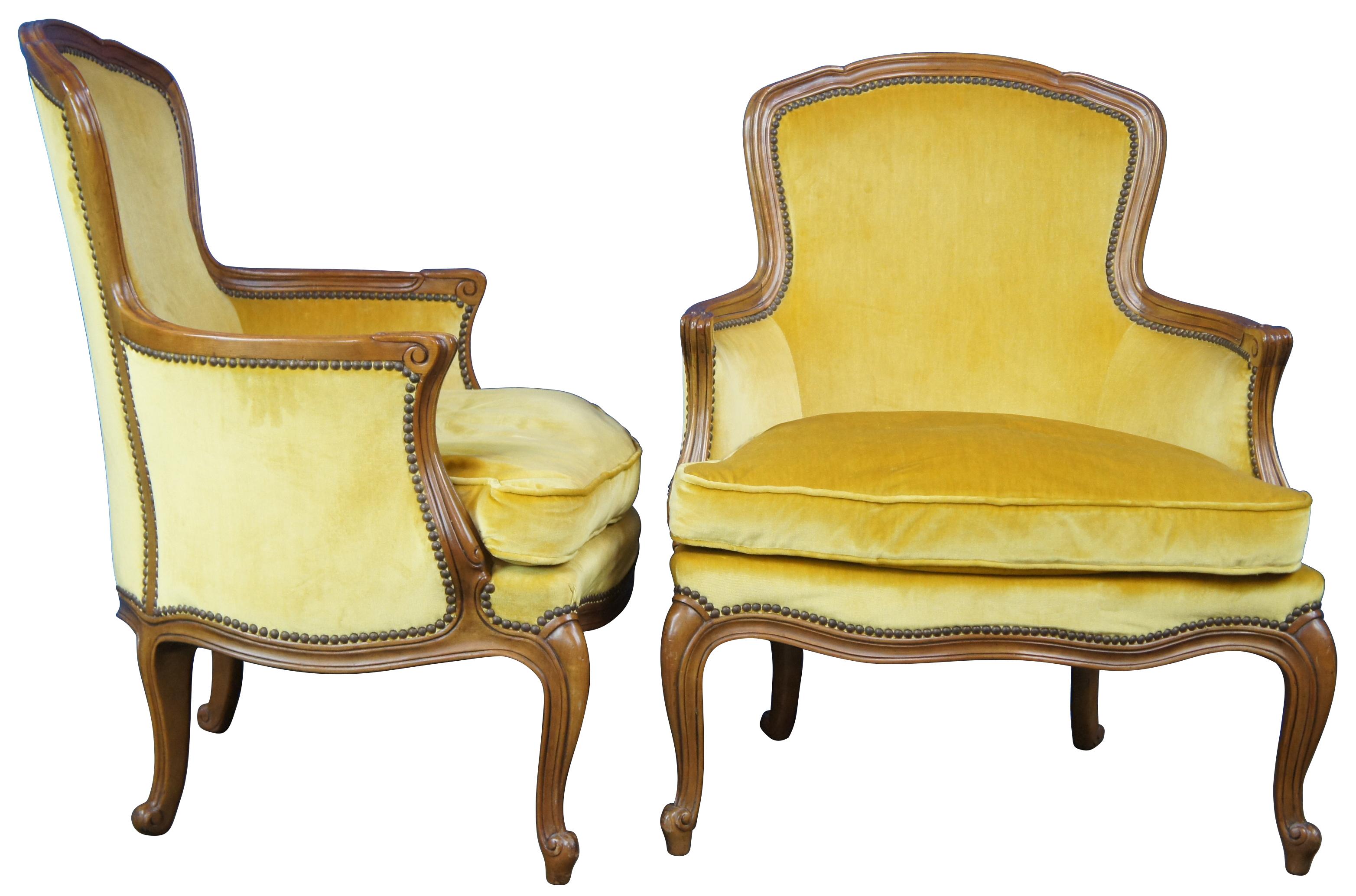 Pair of two vintage Baker Furniture Louis XV Bergere armchairs, circa mide 20th century. Made of walnut featuring serpentine form with velvet upholstery, nailhead trim and cabriole legs.

Provenance : Jerome Schottenstein Estate, Columbus Ohio.