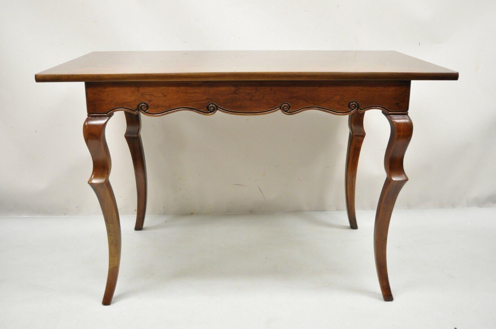 Baker French Provincial Cherry Marquetry Inlay Console Table Desk. Item features shapely saber legs, marquetry inlaid top, solid wood construction, beautiful wood grain, finished back, original label, 1 dovetailed drawer, quality American