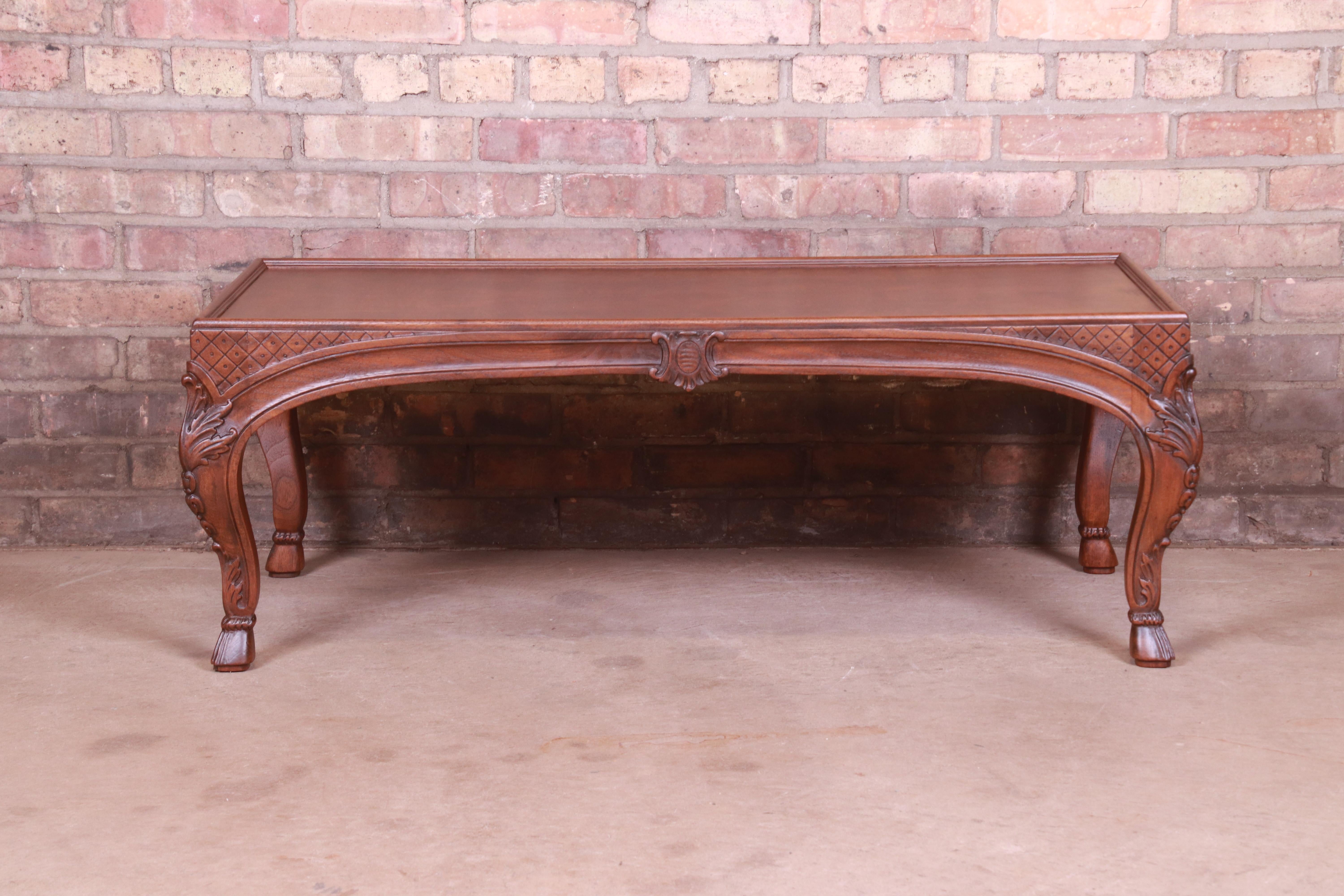 A gorgeous French Provincial Louis XV style coffee table

By Baker Furniture

USA, Circa 1960s

Book-matched burled walnut top, with carved solid walnut legs.

Measures: 42