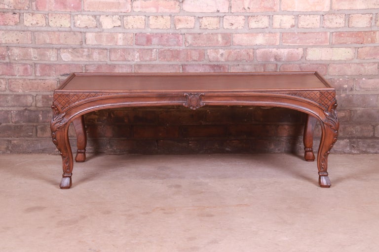 A gorgeous French Provincial Louis XV style coffee table

By Baker Furniture

USA, Circa 1960s

Book-matched burled walnut top, with carved solid walnut legs.

Measures: 42