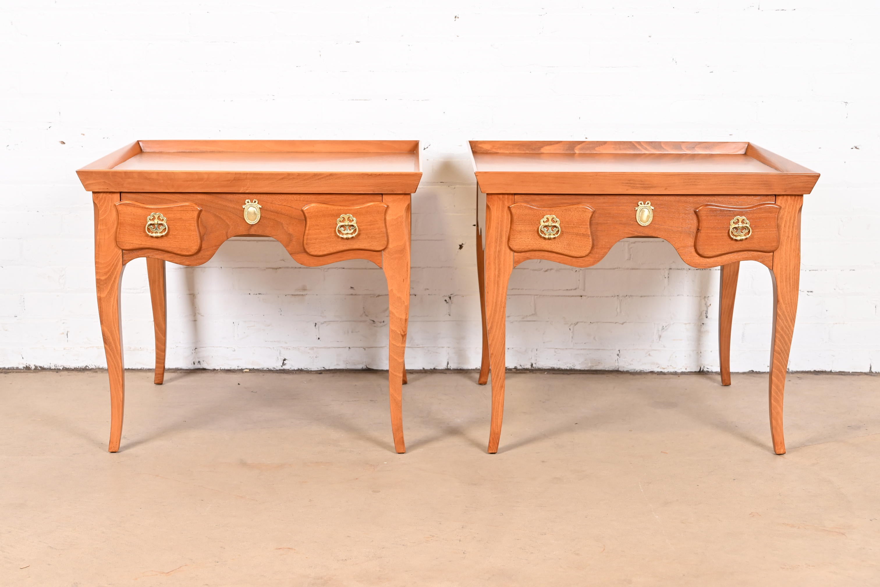 A gorgeous pair of French Provincial Louis XV style bedside tables or end tables

By Baker Furniture, 