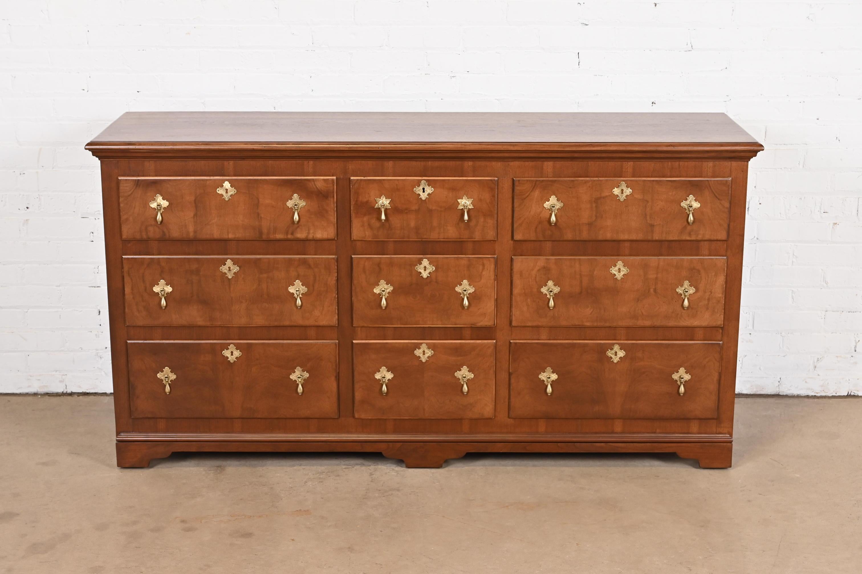 A gorgeous 18th Century Flemish or Georgian style long dresser or credenza

By Baker Furniture

USA, Mid-20th Century

Stunning book-matched burled walnut, with original brass hardware.

Measures: 66