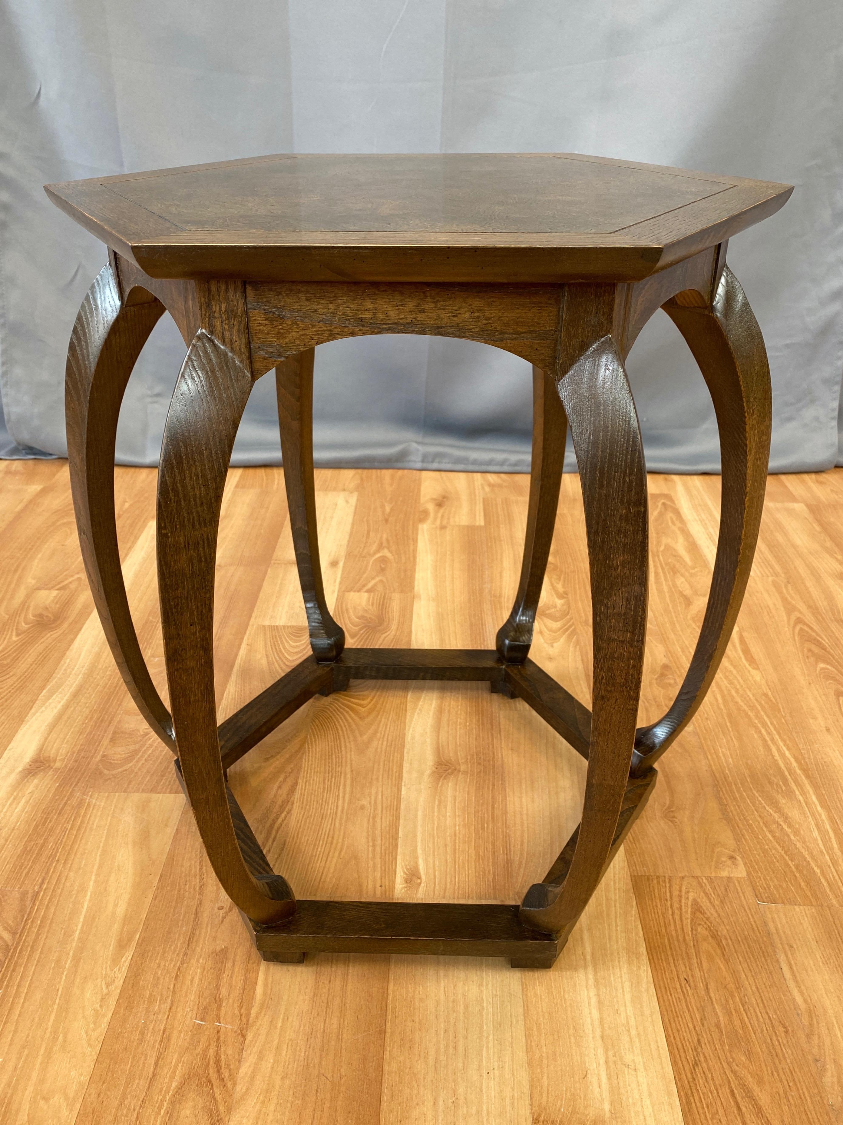 A 1960s Asian-inspired hexagonal oak side table or stool with burl wood top by Baker Furniture, likely from Michael Taylor's timeless Far East Collection for the company.

Well crafted and perfectly proportioned solid oak silhouette distinguished