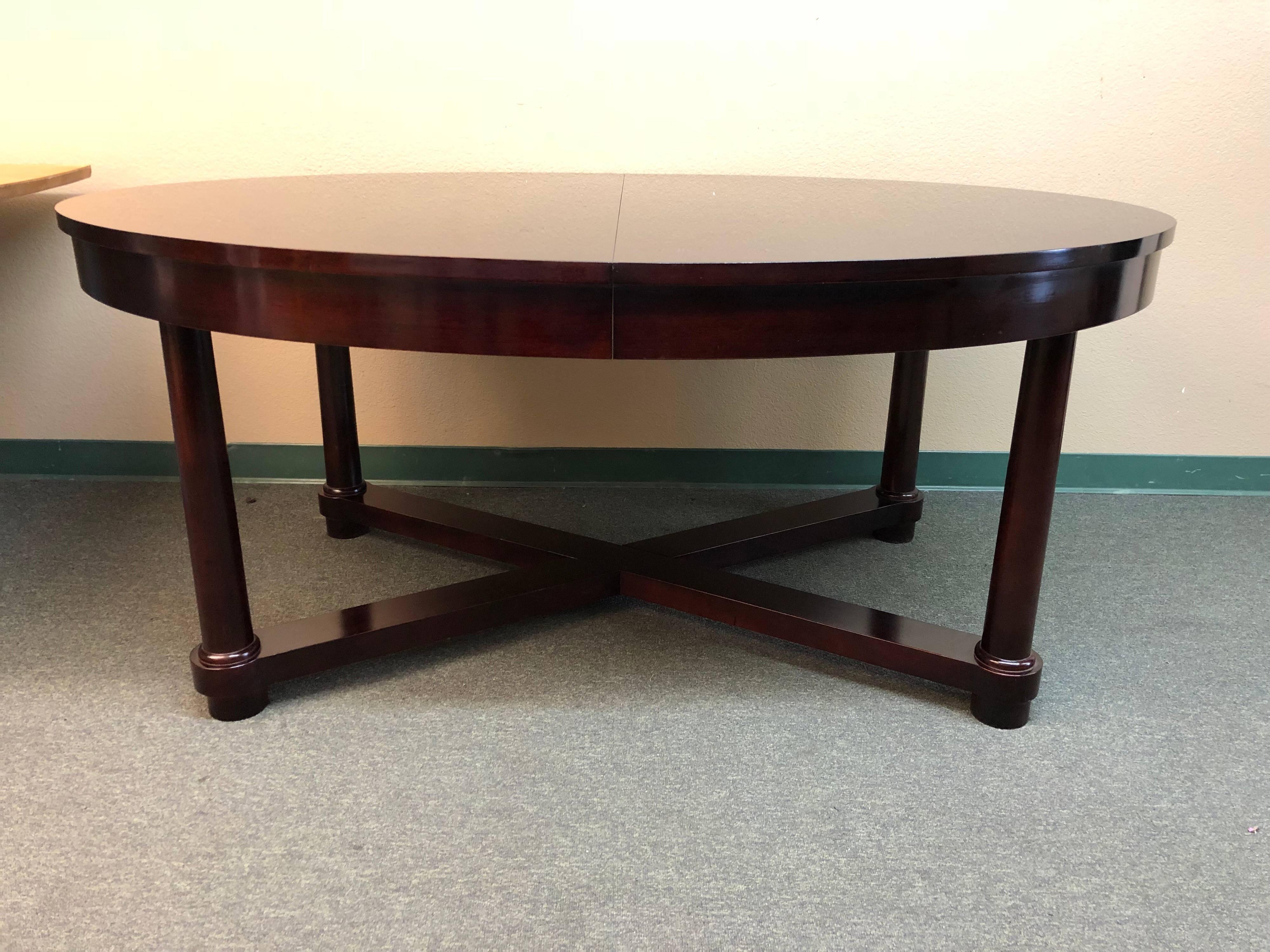 A Barbara Barry dining table. The table was produced by Baker furniture Company. The Mahogany oval dining table in the style of the 19th century English dining table, paired down to a more elementary form, the extended oval dining table embodies the