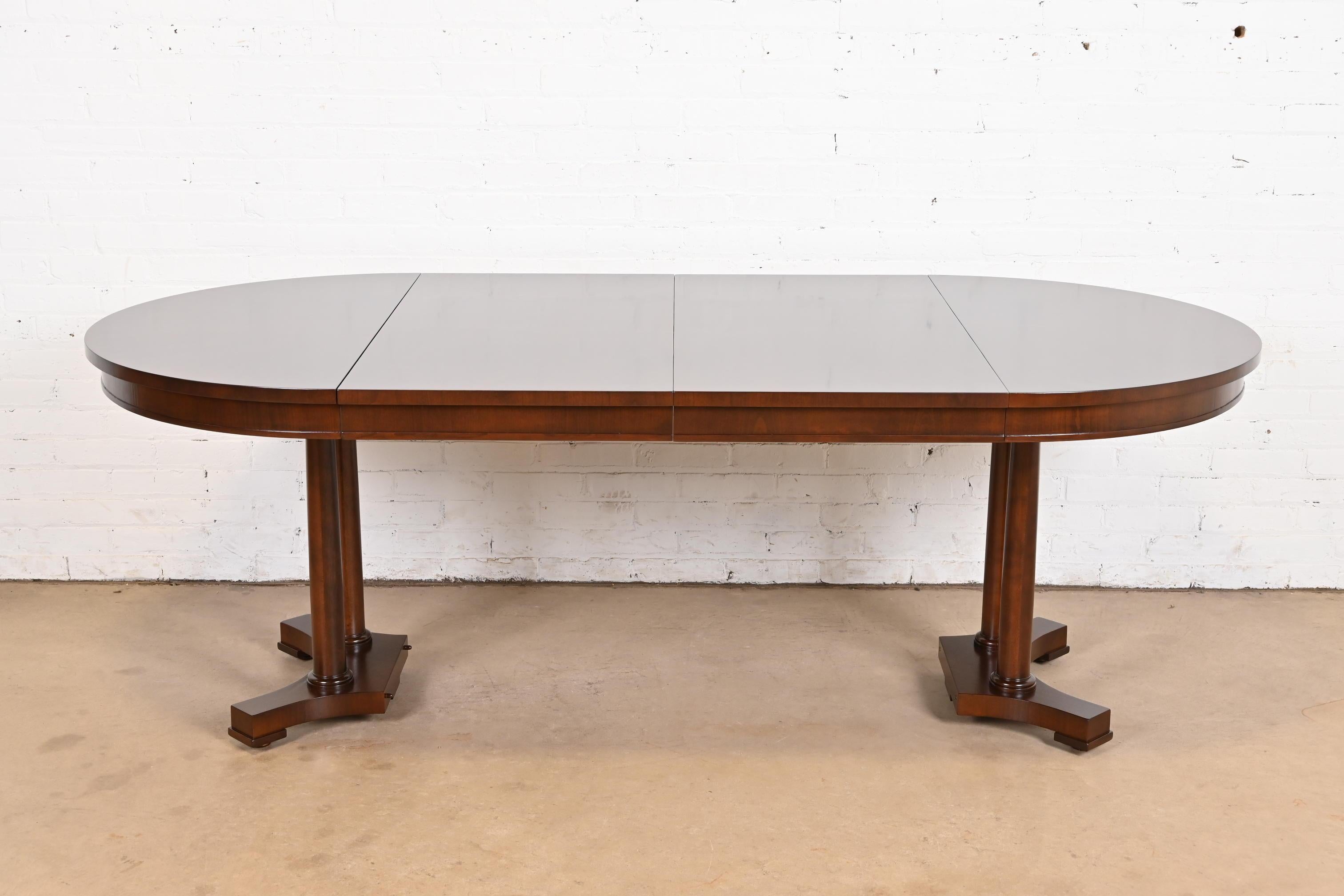 A gorgeous Biedermeier, Neoclassical, Empire, or Regency style split pedestal extension dining table

By Baker Furniture

USA, Circa 1960s

Beautiful book-matched cherry wood top, with solid cherry columned split pedestal.

Measures: 42