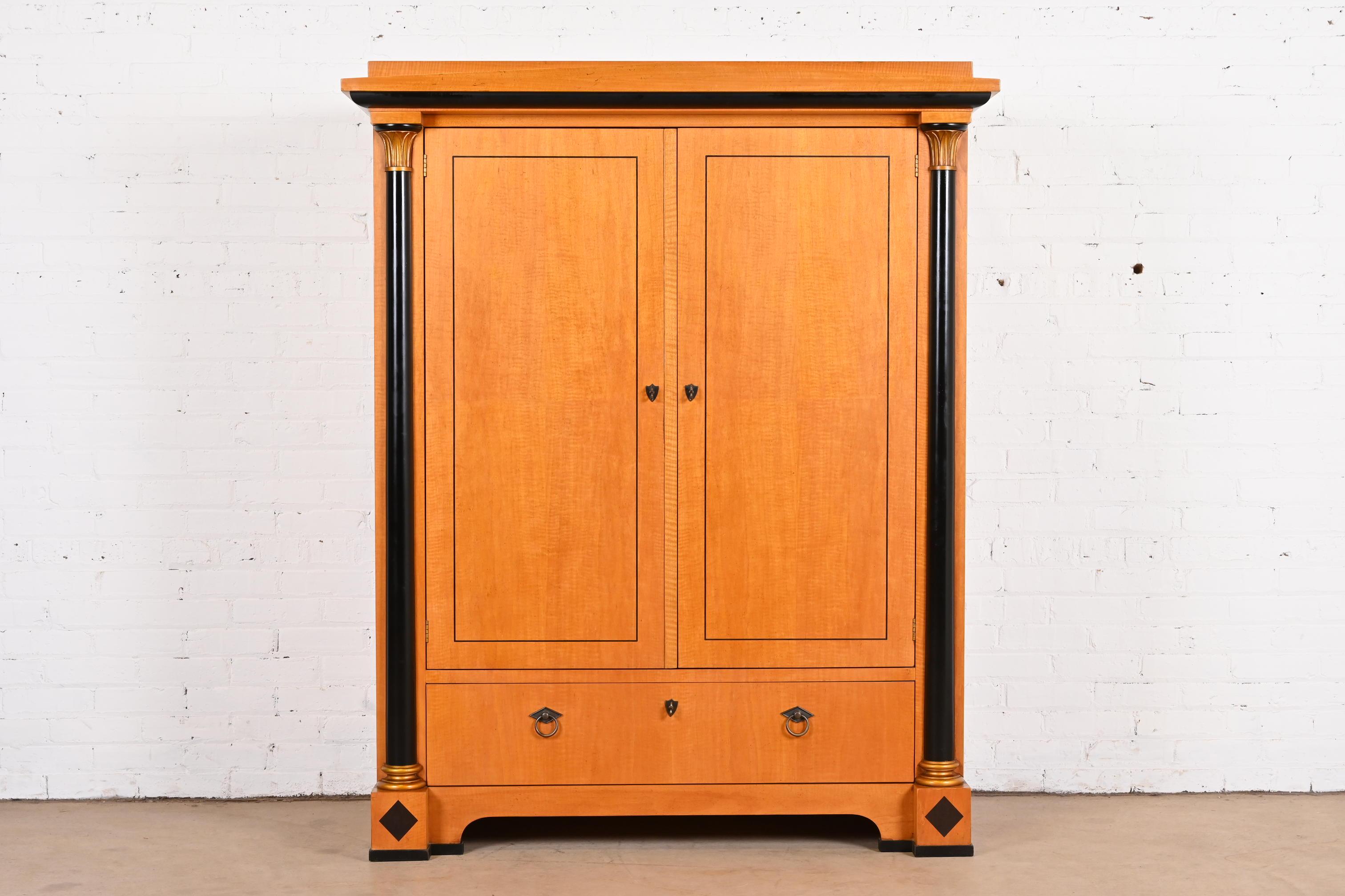 A gorgeous Biedermeier or Neoclassical style armoire or wardrobe dresser

By Baker Furniture

USA, circa 1980s

Beautiful primavera wood, with ebonized columns, and original brass hardware.

Measures: 52