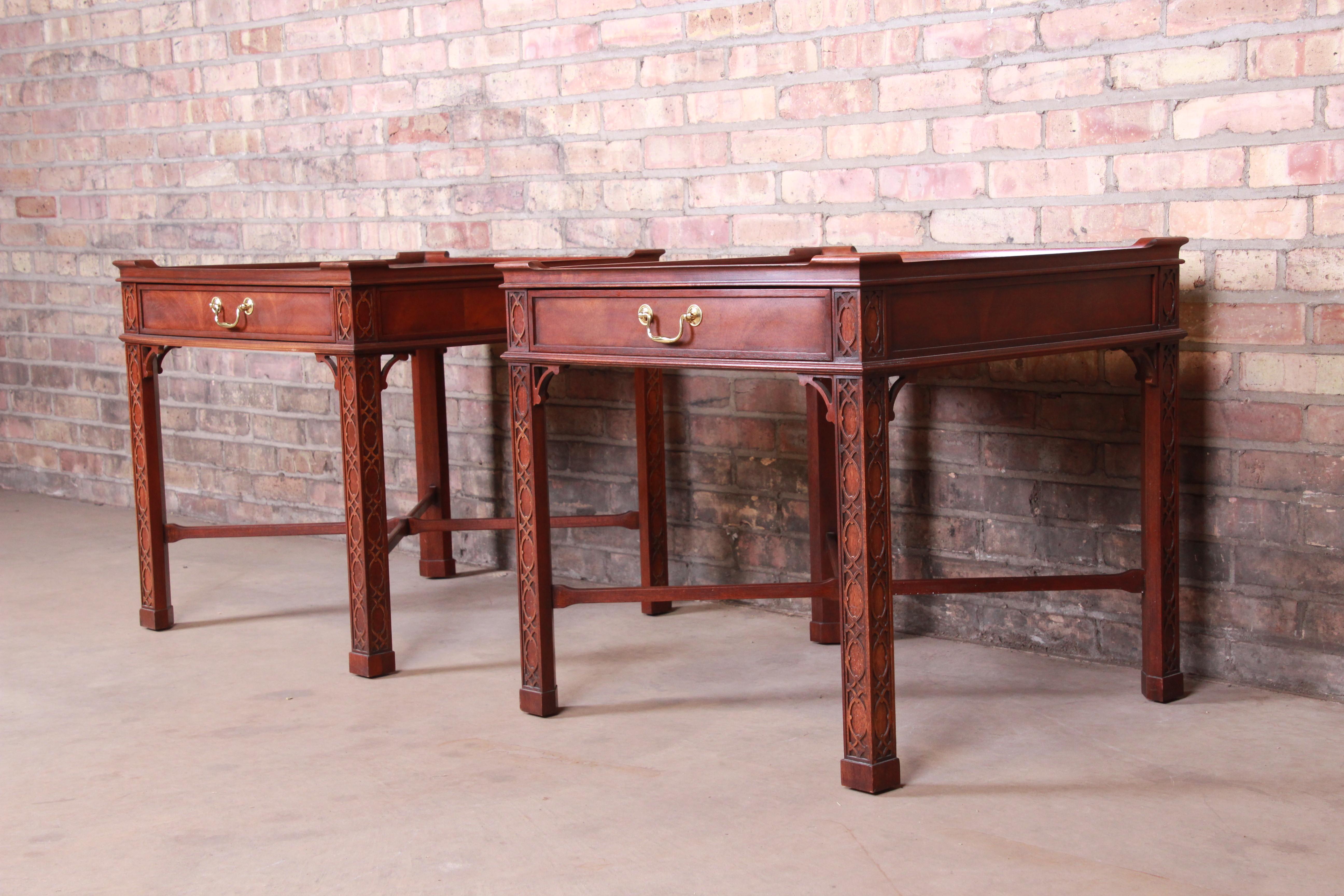 A gorgeous pair of Chippendale style nightstands or end tables

By Baker Furniture

USA, circa 1980s

Carved mahogany, with original brass hardware.

Measures: 25.88