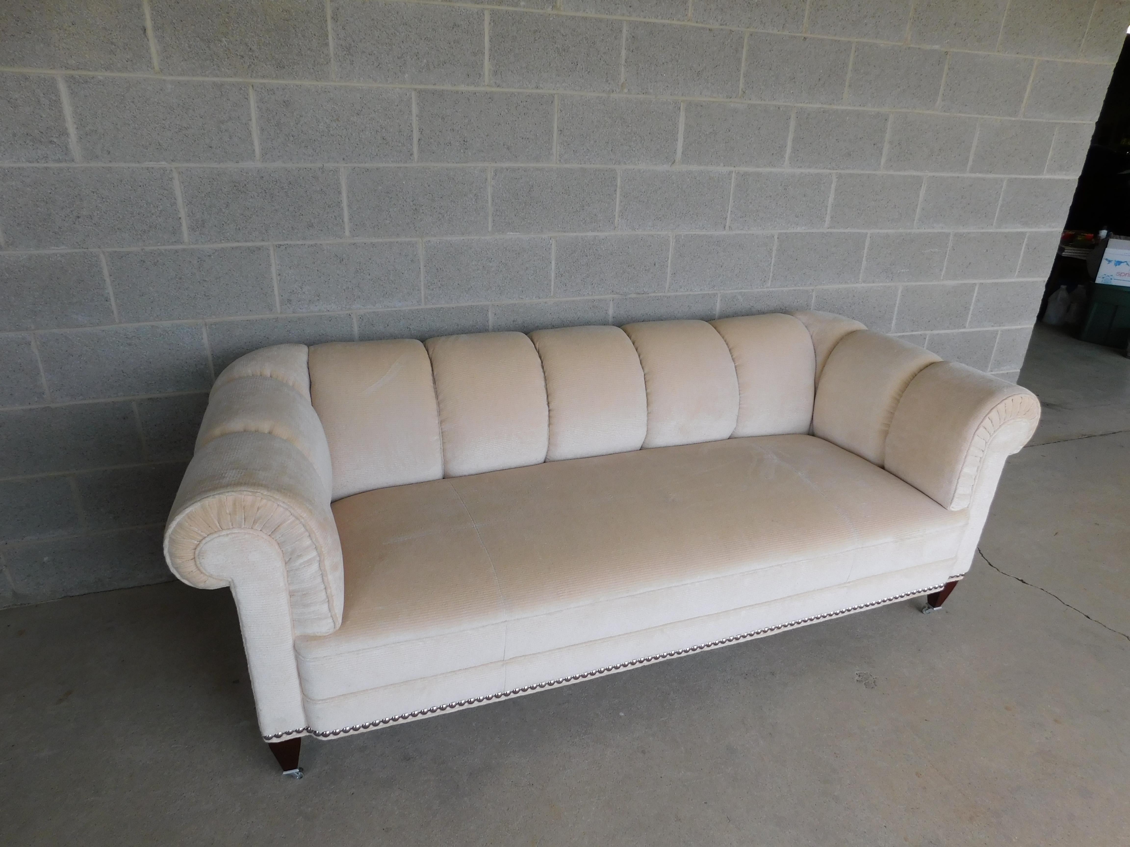 Channel back styles blend to create a unique and original sofa design by Barbara Barry for Baker Furniture. Elegantly upholstered in soft velvet with well supported Down Feather and Synthetic Blend Cushioning.

The sofa has a comfortable seat well