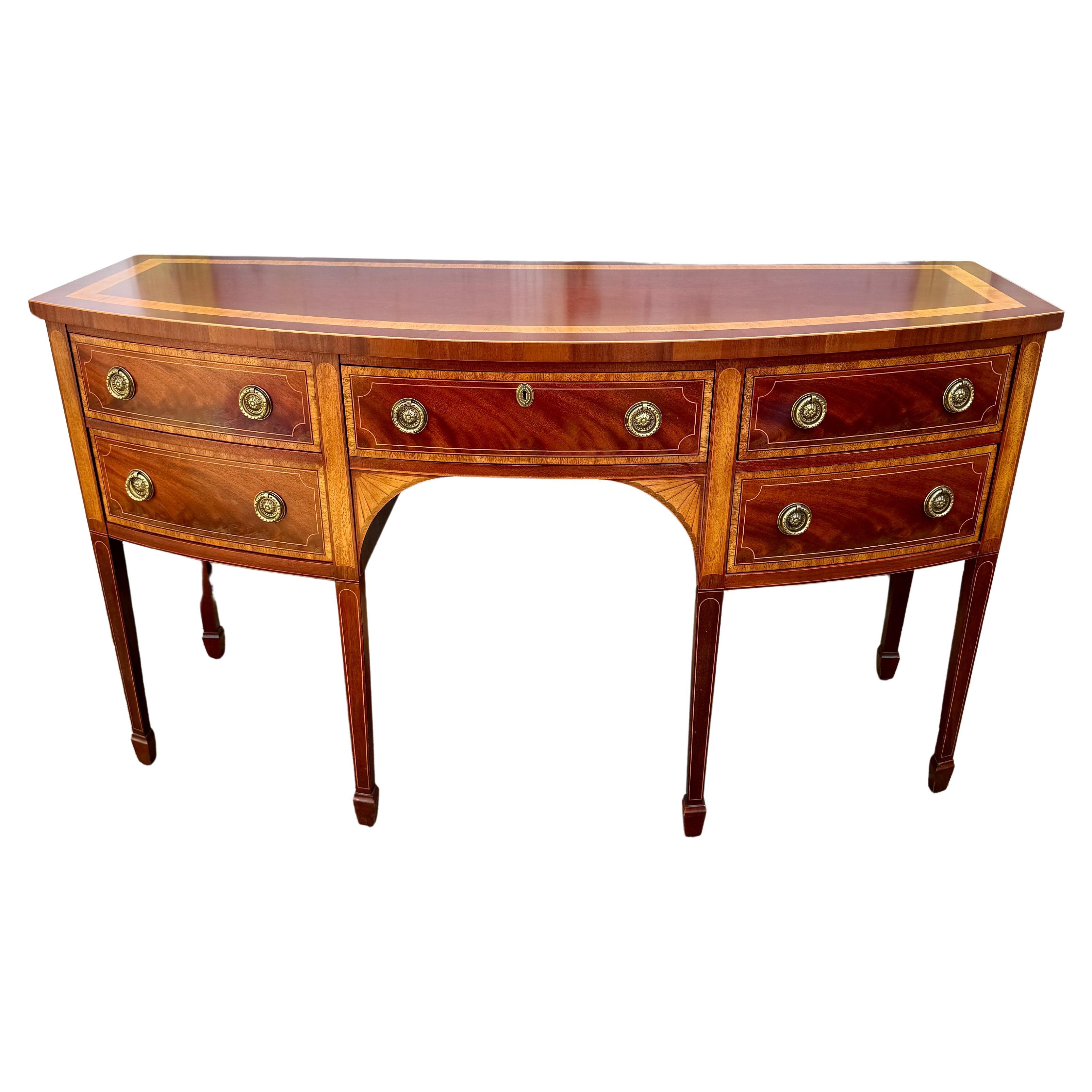 Traditional Charleston Collection Inlaid Sideboard by Baker Furniture Company.
This sideboard embodies classic elegance and exceptional craftsmanship, making it a distinguished addition to any dining room or living space. The sideboard's middle