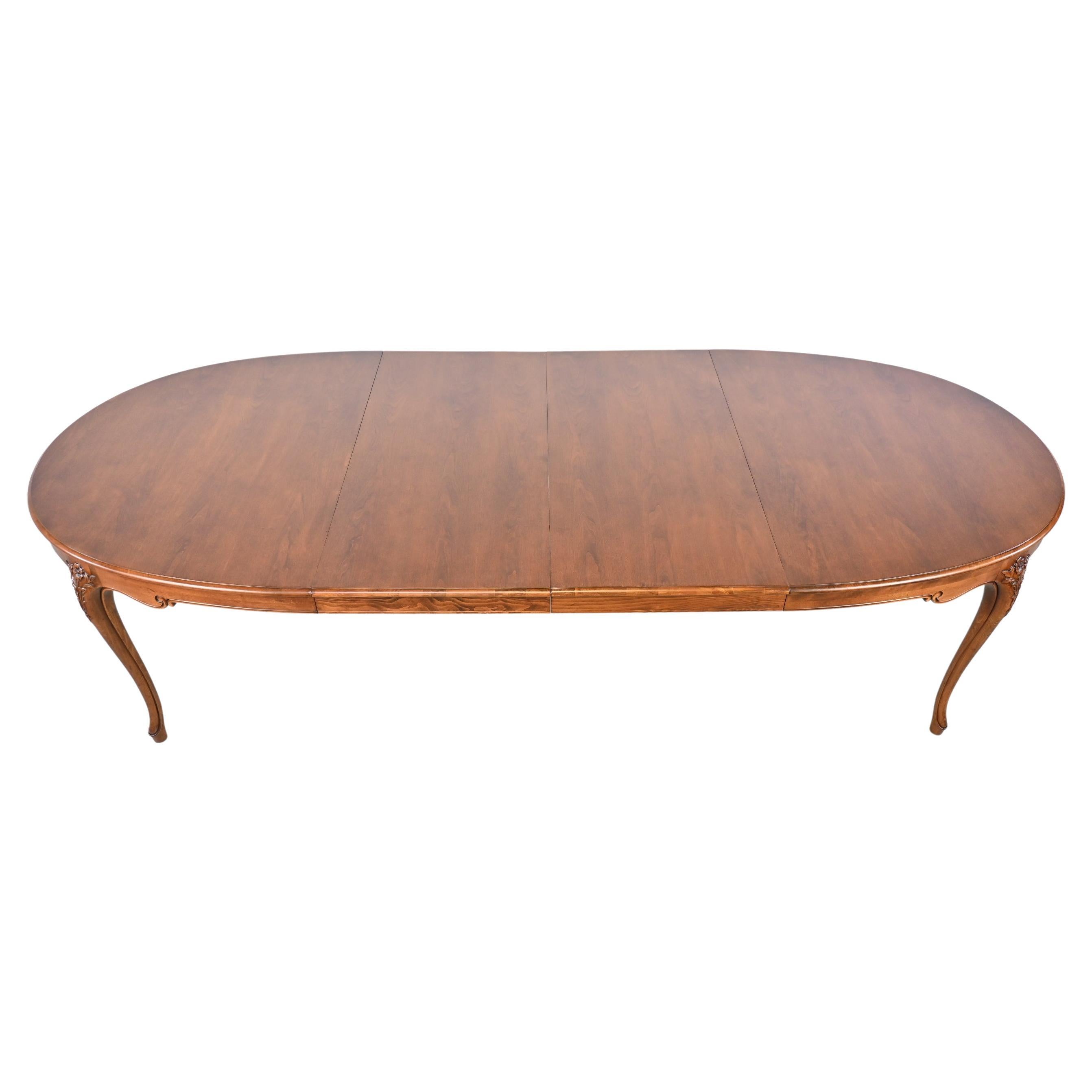 Baker Furniture French provincial carved cherry extension dining table.

Baker Furniture, USA, 1980s.

Measures: 67 wide x 45.75 deep x 29.25 high. Fully extended table measures 109