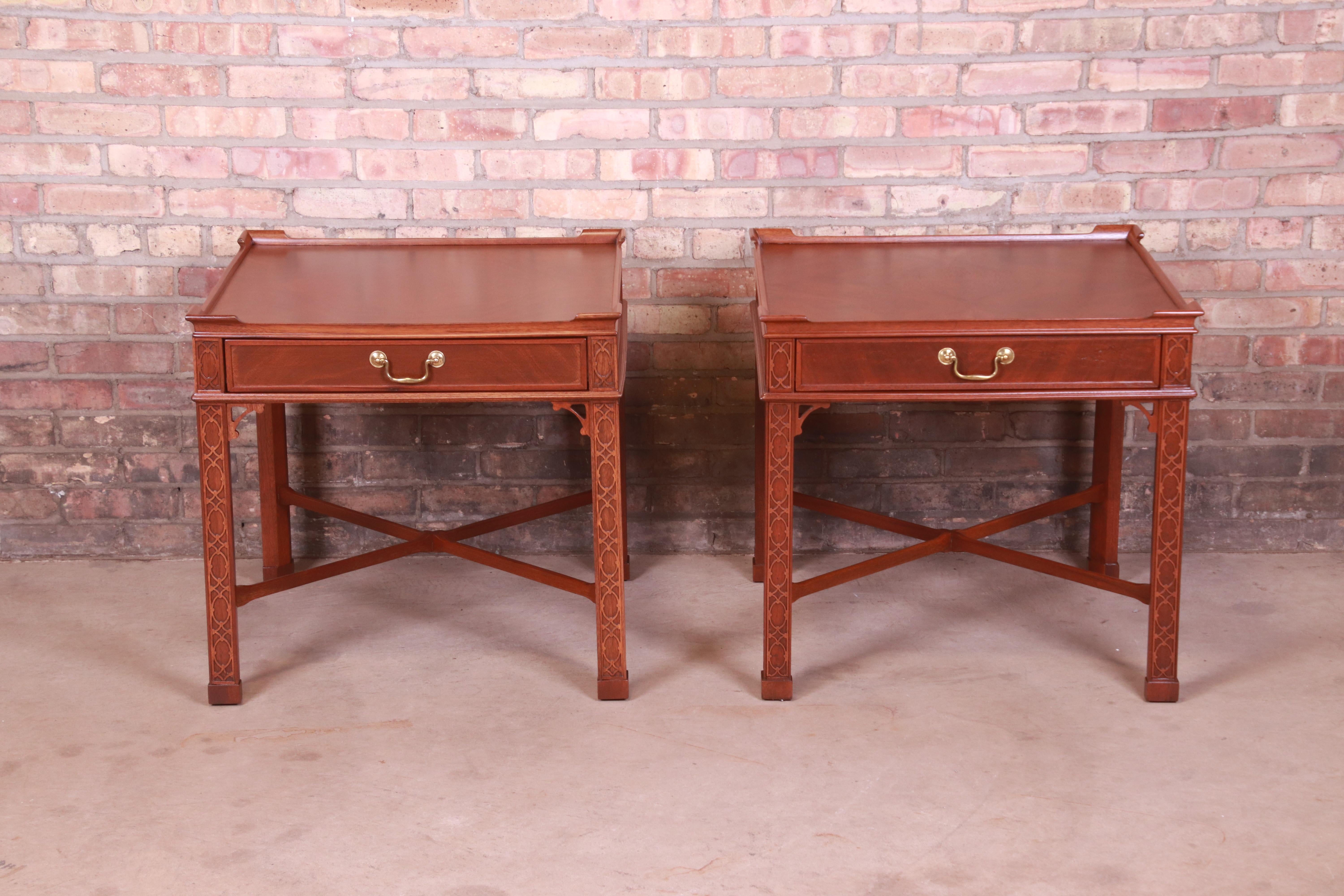 A gorgeous pair of Chinese Chippendale style nightstands or end tables

By Baker Furniture

USA, Circa 1980s

Carved mahogany, with original brass hardware.

Measures: 26