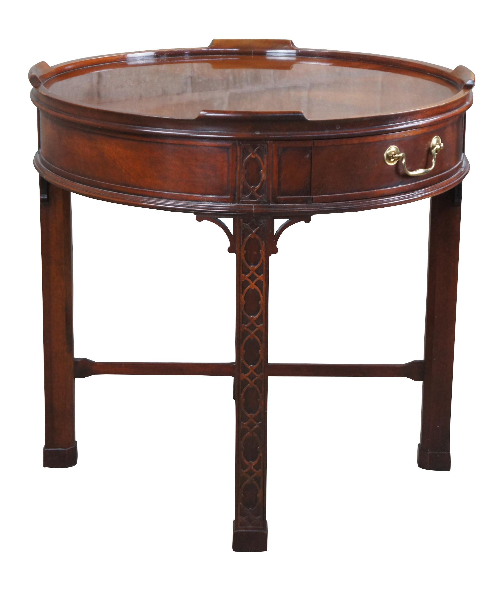 A gorgeous side or accent table by Baker Furniture, Circa last quarter 20th century. Drawing inspiration from English and Chinese Chippendale styling.  Made from mahogany with a matchbook banded inset top.  The frieze features one dovetailed drawer