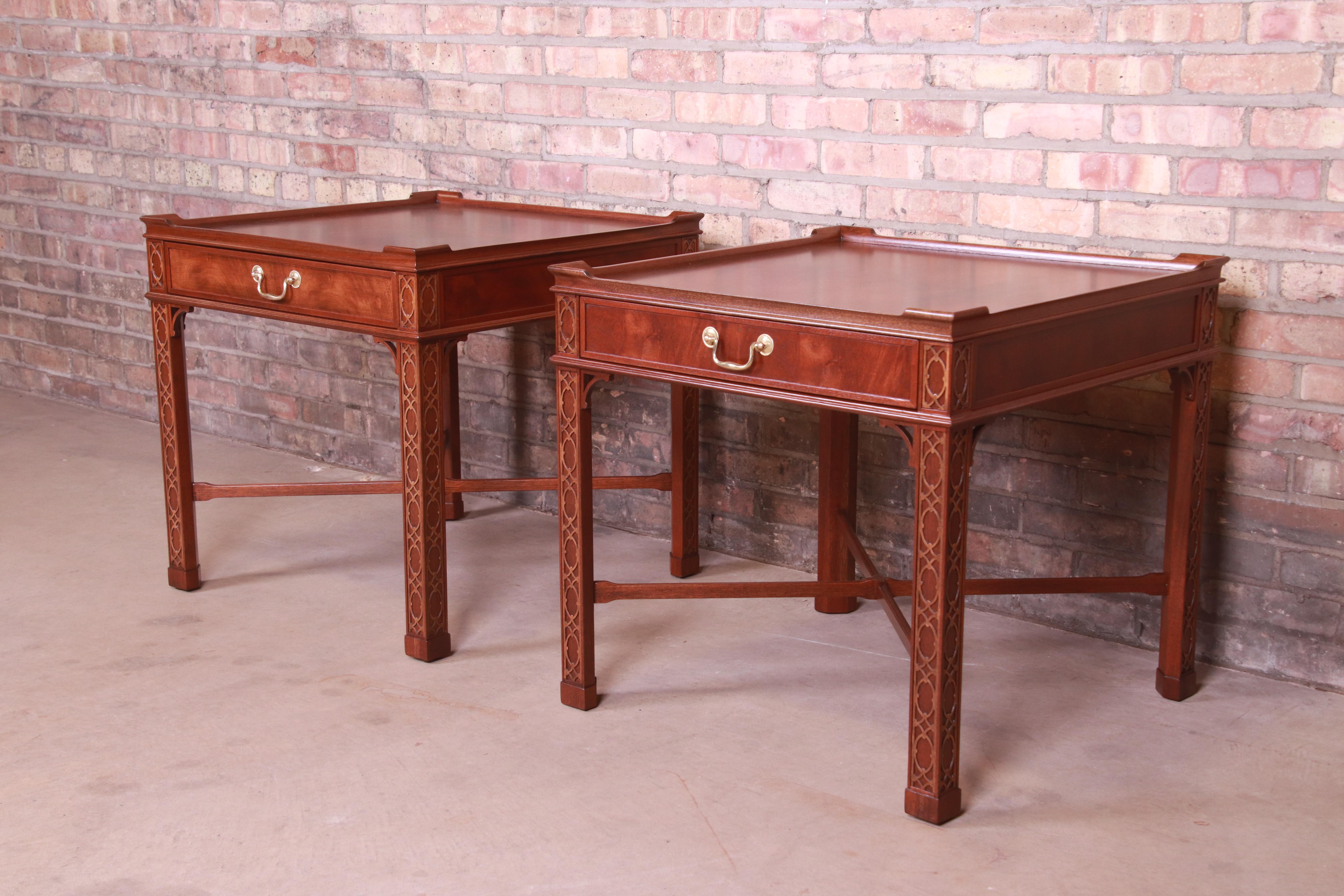 A gorgeous pair of Chinese Chippendale style nightstands or end tables

By Baker Furniture

USA, circa 1980s

Carved mahogany, with original brass hardware.

Measures: 25.75