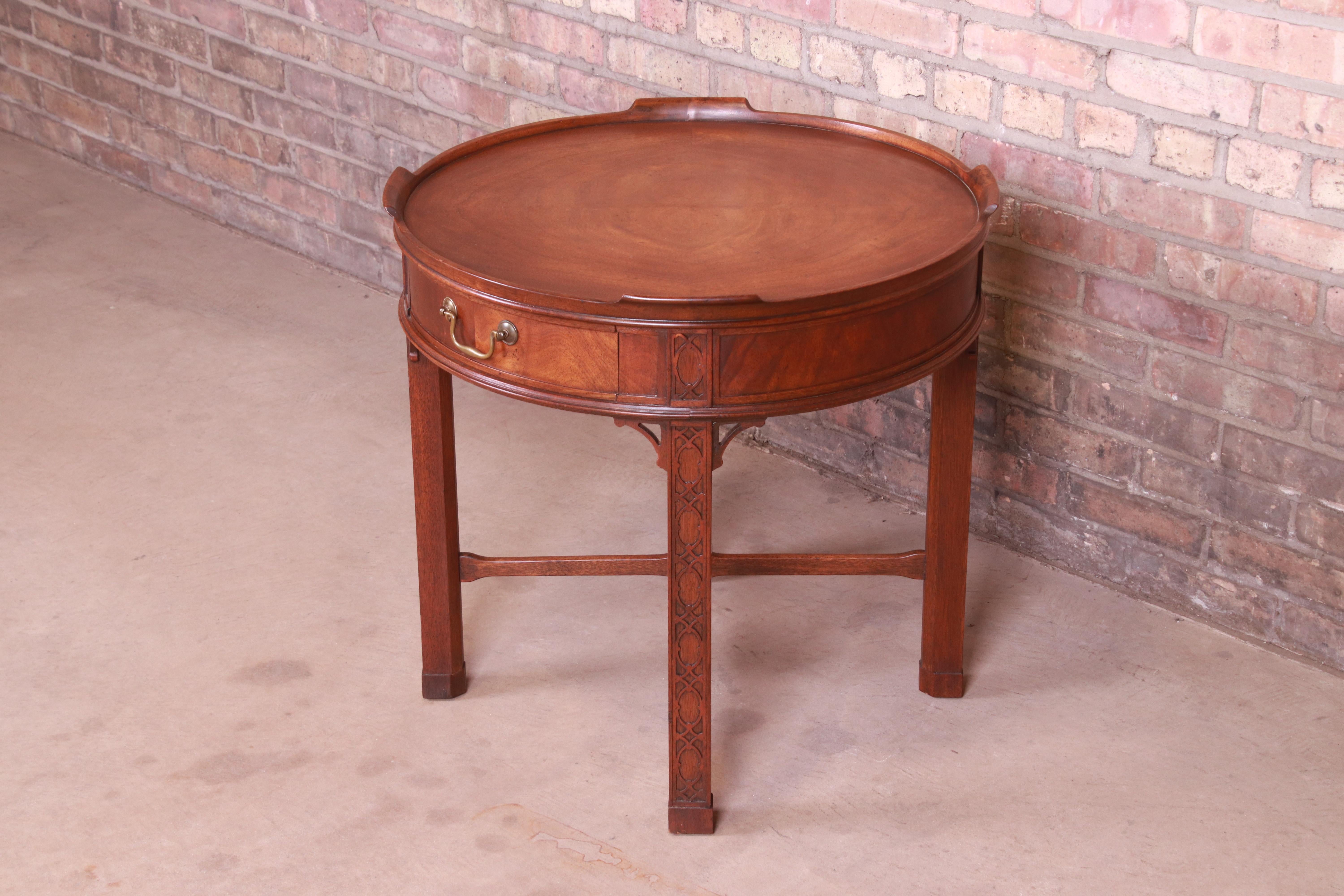 A gorgeous Chinese Chippendale style occasional side table, tea table, or nightstand

By Baker Furniture

USA, Circa 1980s

Carved mahogany, with original brass hardware.

Measures: 25.5