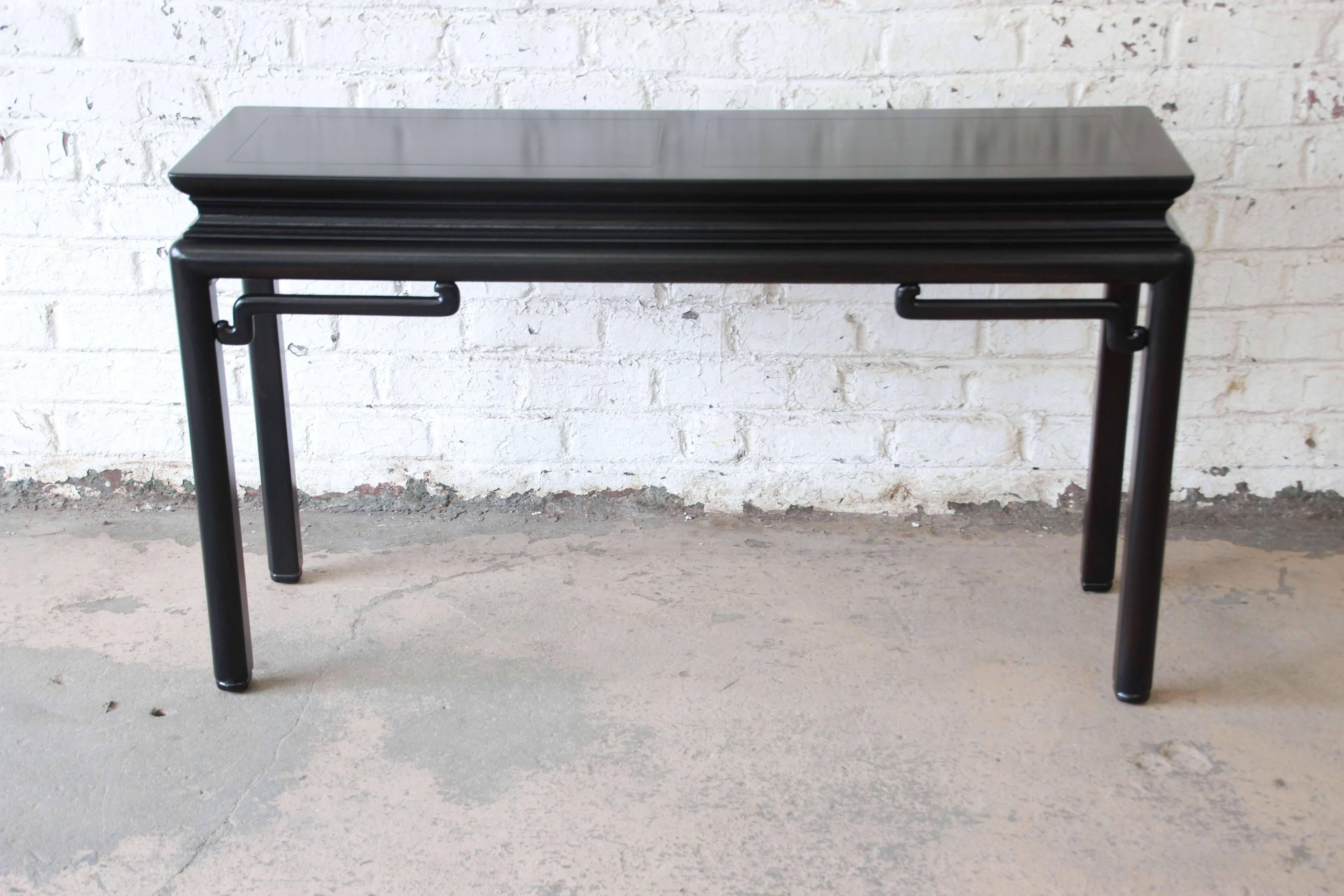 Offering a beautiful ebonized Chinoiserie console or sofa table by Michael Taylor for Baker. This piece has been newly refinished and features and elegant Asian design and quality expected by Baker. This table is apart of the Far East Collection