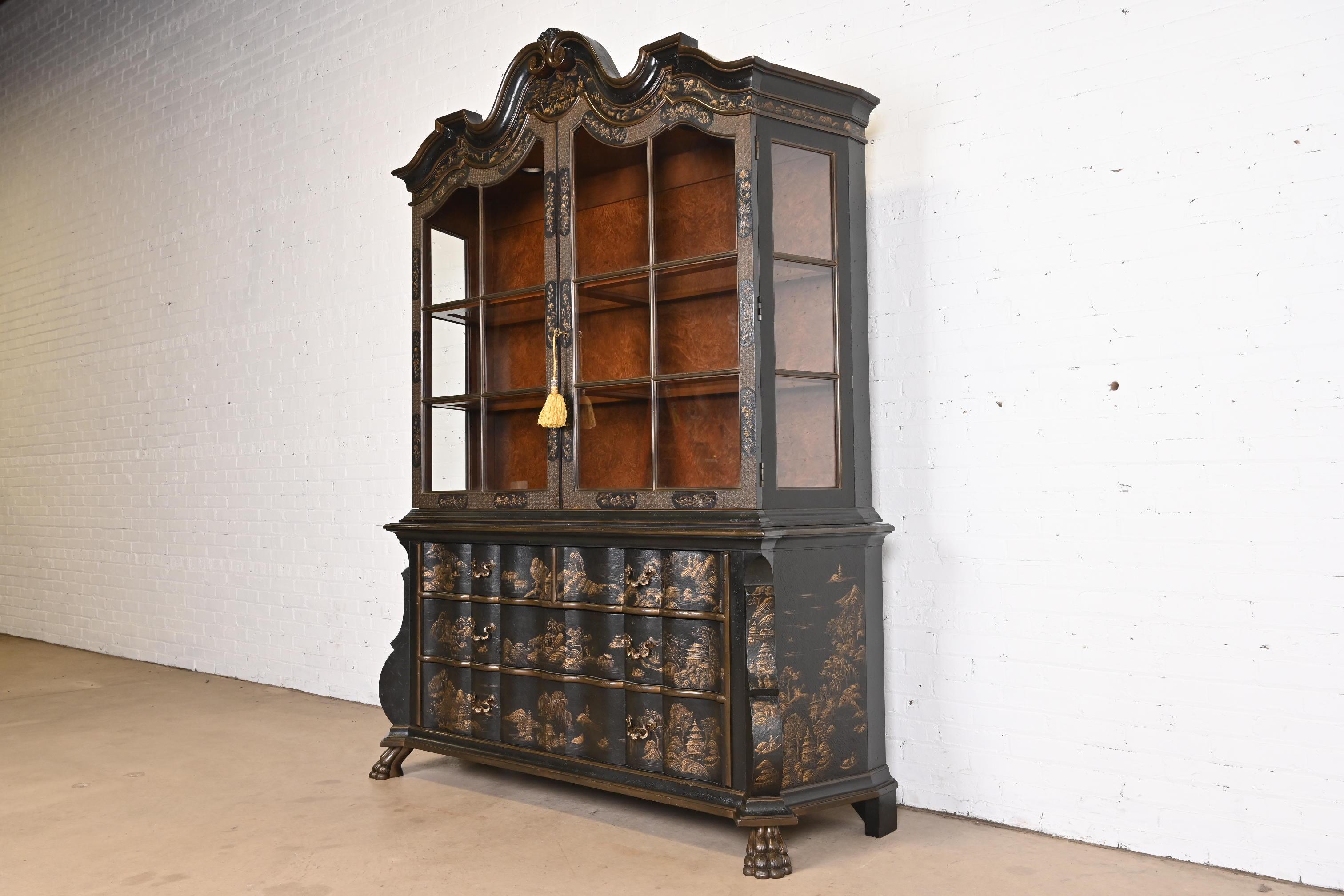 A gorgeous Dutch Baroque Chinoiserie style breakfront bookcase or dining cabinet

By Baker Furniture

USA, Late 20th Century

Black lacquer, with Asian scenes painted in gold relief, mullioned glass front doors, and burl wood interior. Cabinet