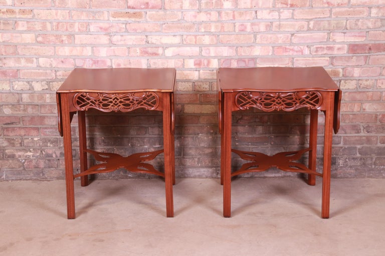 An exceptional pair of Chippendale or Georgian style carved mahogany pembroke drop-leaf side tables or bedside tables

By Baker Furniture, 