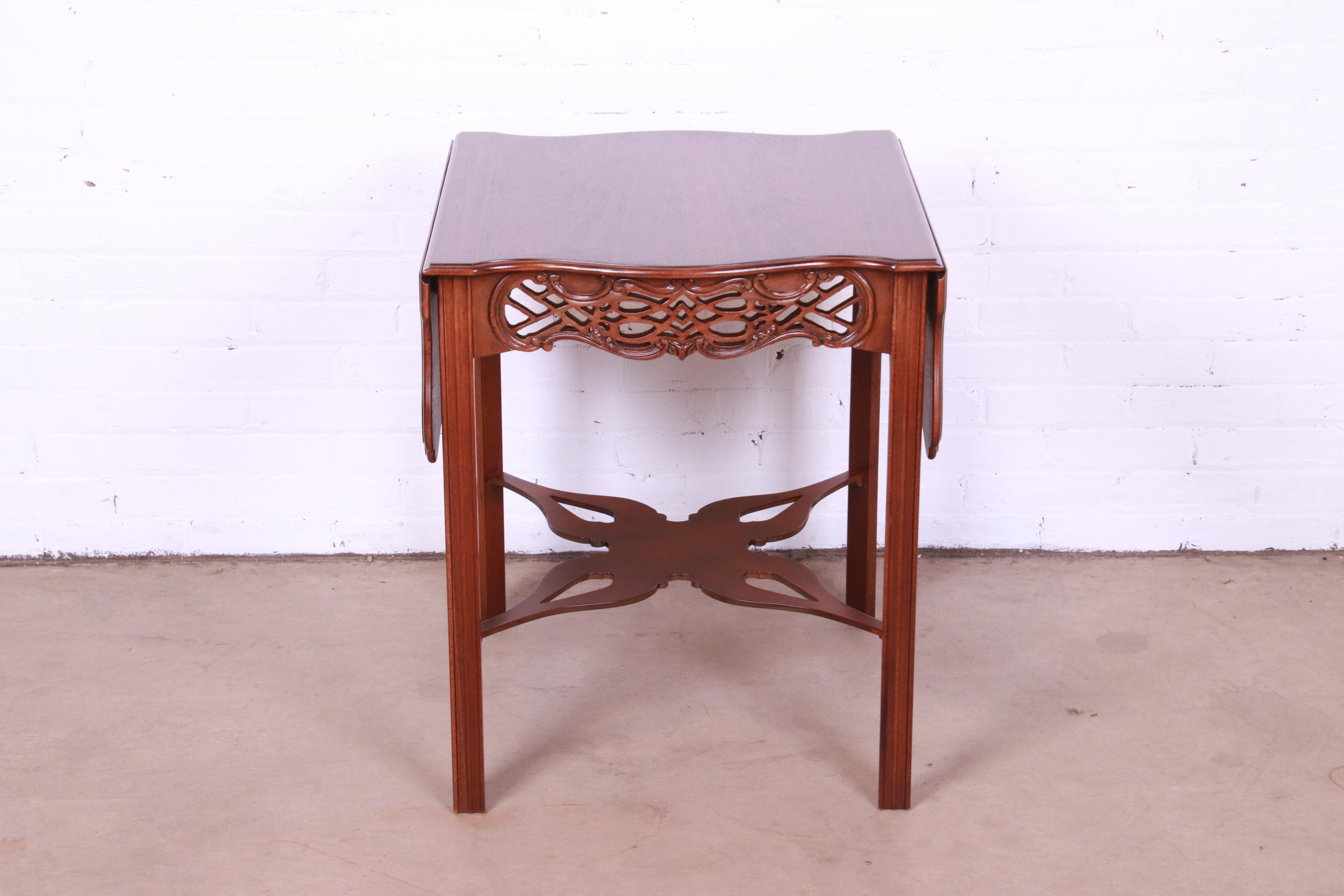 An exceptional Chippendale or Georgian style carved mahogany pembroke drop-leaf occasional side table or tea table

By Baker Furniture, 