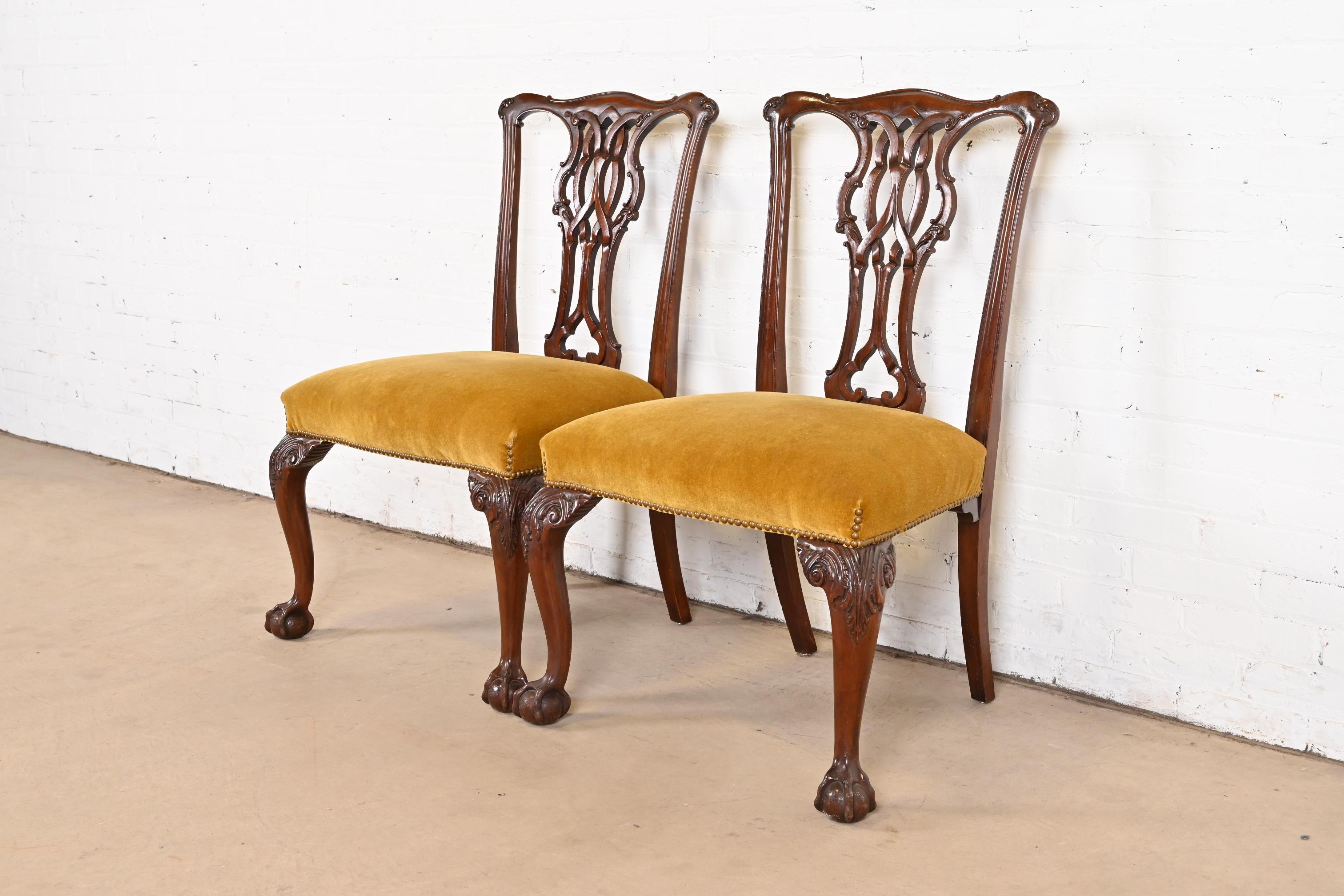 An exceptional pair of Chippendale or Georgian style side chairs or dining chairs

By Baker Furniture

USA, Circa 1980s

Carved solid mahogany frames, with cabriole legs, ball and claw feet, and brass studded velvet upholstered seats.

Measures: