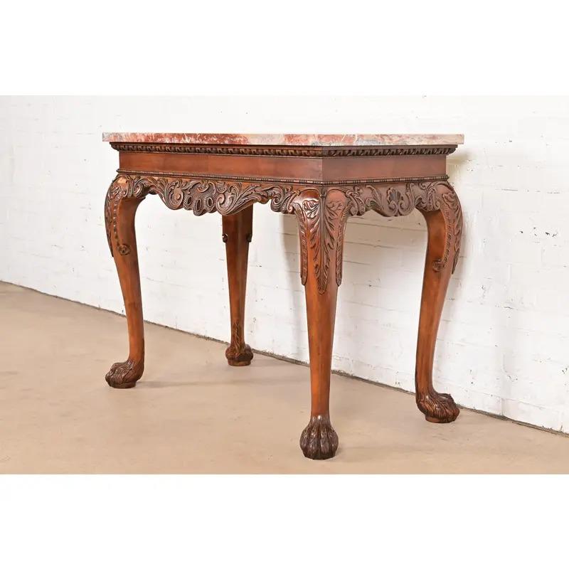 A gorgeous Chippendale or Georgian style console table, entry table, or sofa table

By Baker Furniture

USA, Circa 1980s

Carved walnut, with beautiful marble top, and hairy paw feet.

Measures: 40.25