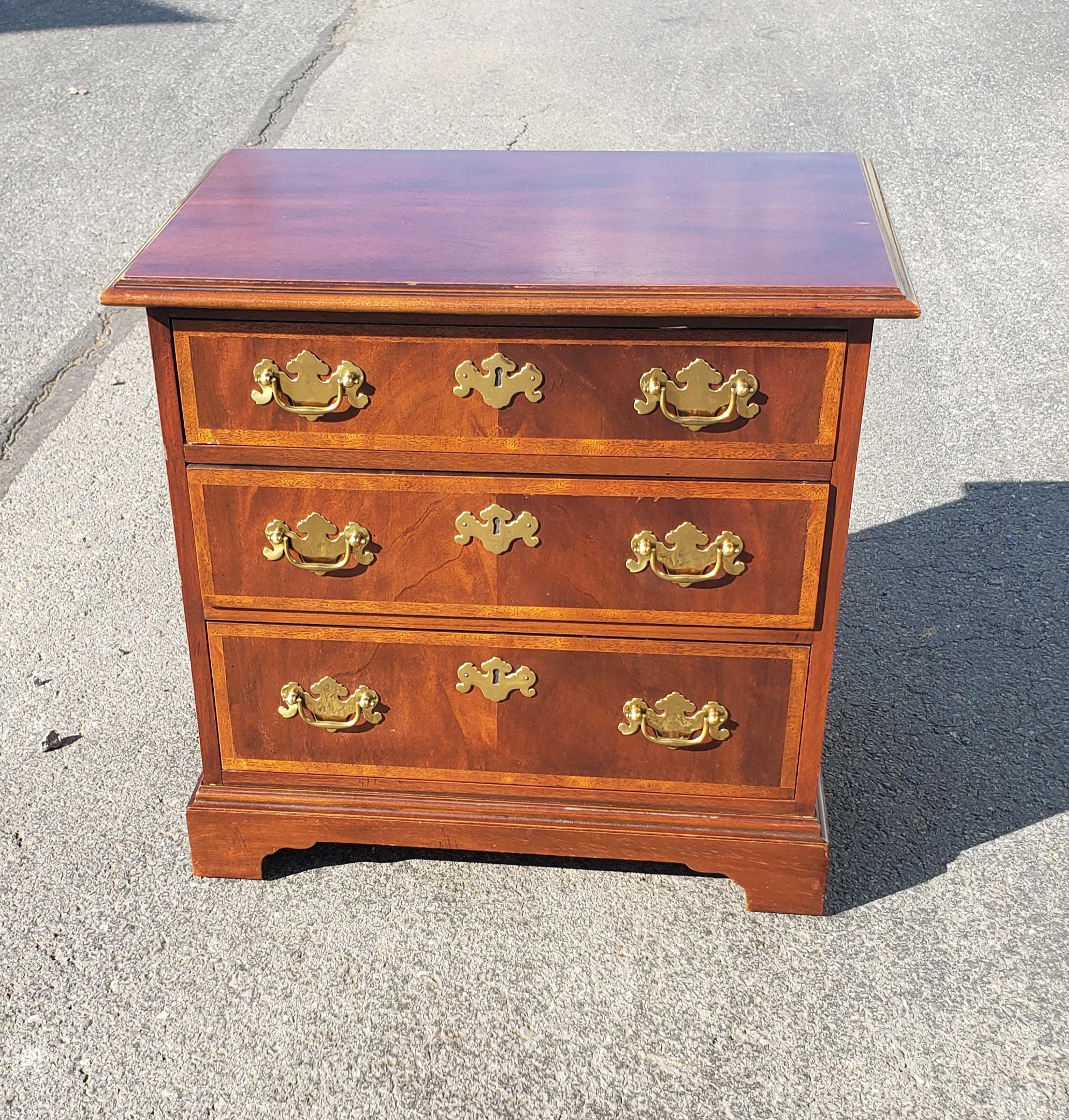 Baker Furniture Chippendale Mahogany and satinwood banded inlay side chest of drawers in very good vintage condition. Finished on all sides. Measures 23