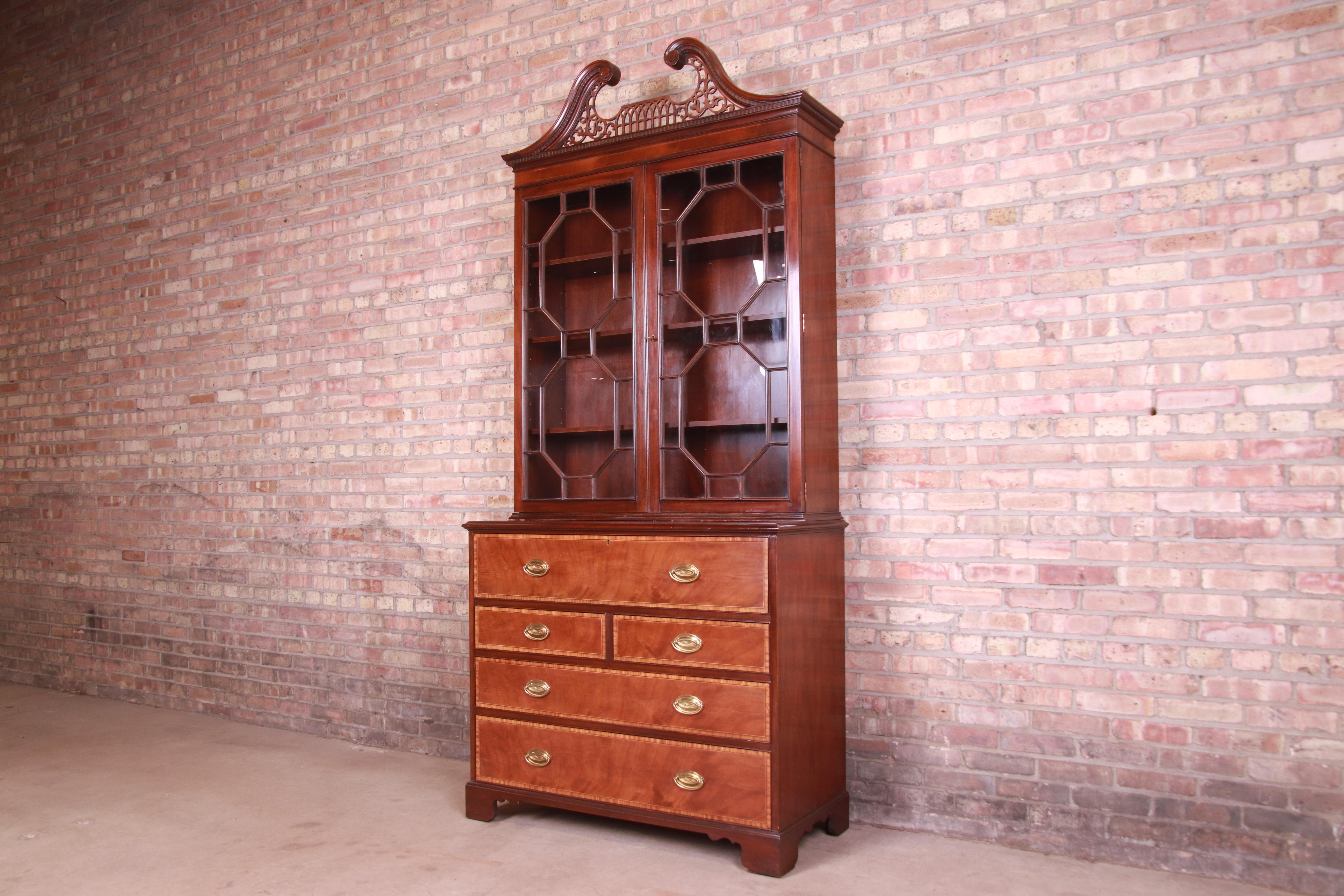 A gorgeous Chippendale or Georgian style bureau with drop front secretary desk and bookcase hutch top

By Baker Furniture

USA, Circa 1980s

Carved mahogany, with satinwood banding, embossed leather writing surface, mullioned glass front
