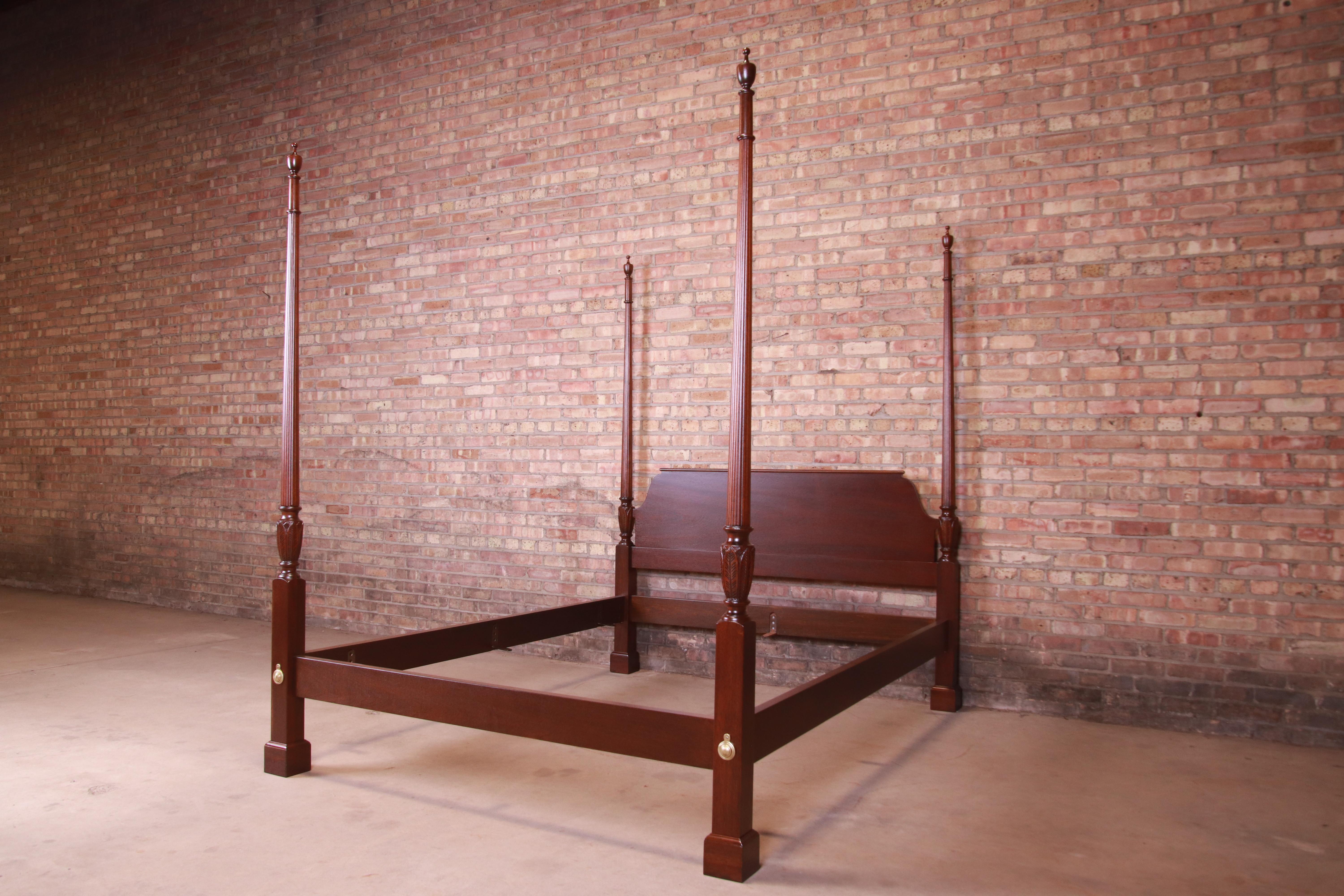 A gorgeous Chippendale style carved mahogany four poster queen size bed.

By Baker Furniture

USA, late 20th century

Measures: 66.25