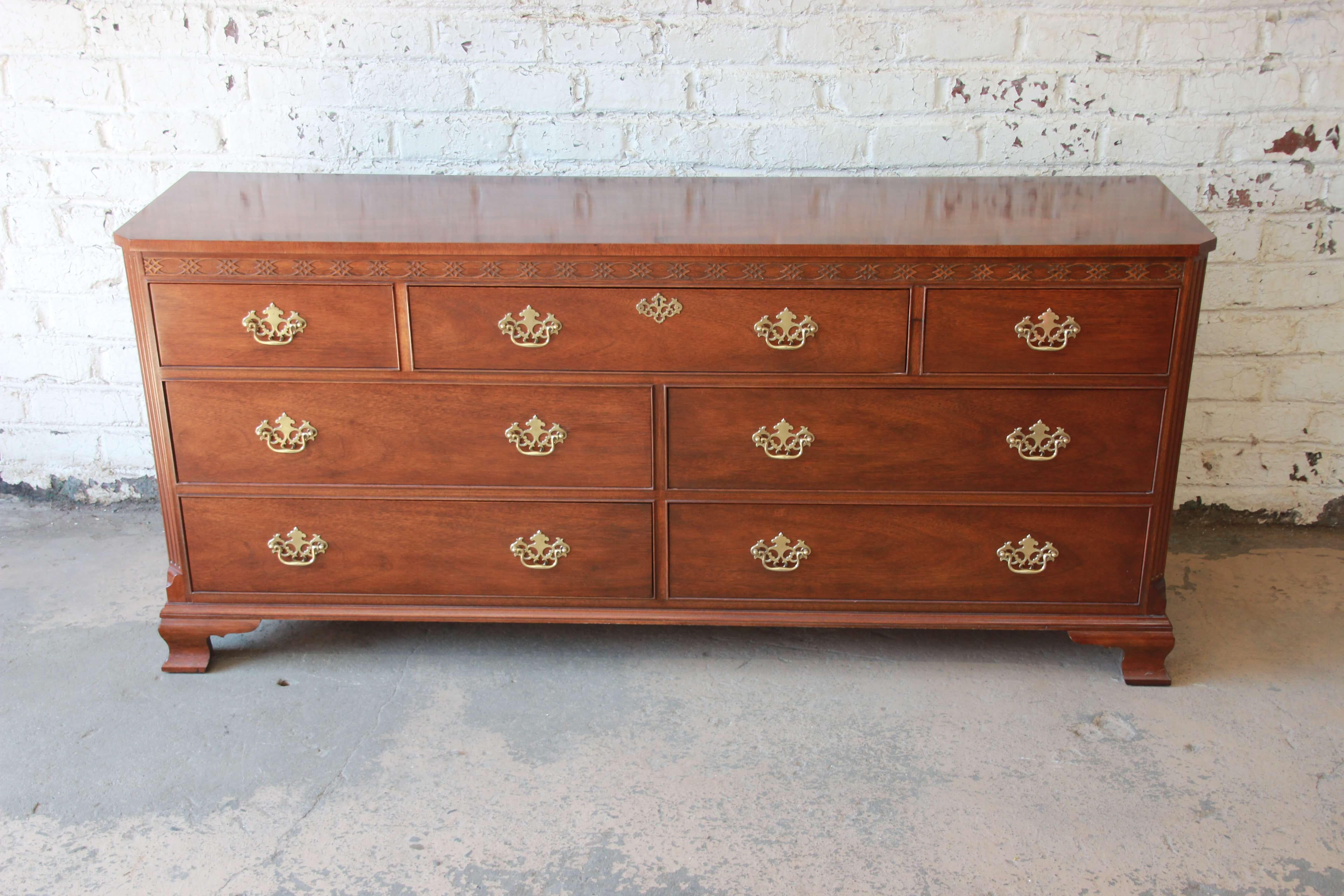 Offering a fantastic Baker Furniture mahogany seven-drawer long dresser. The dresser has beautiful mahogany wood grain with carved details and brass pulls. It has a nice traditional English style and is in great vintage condition with very minor