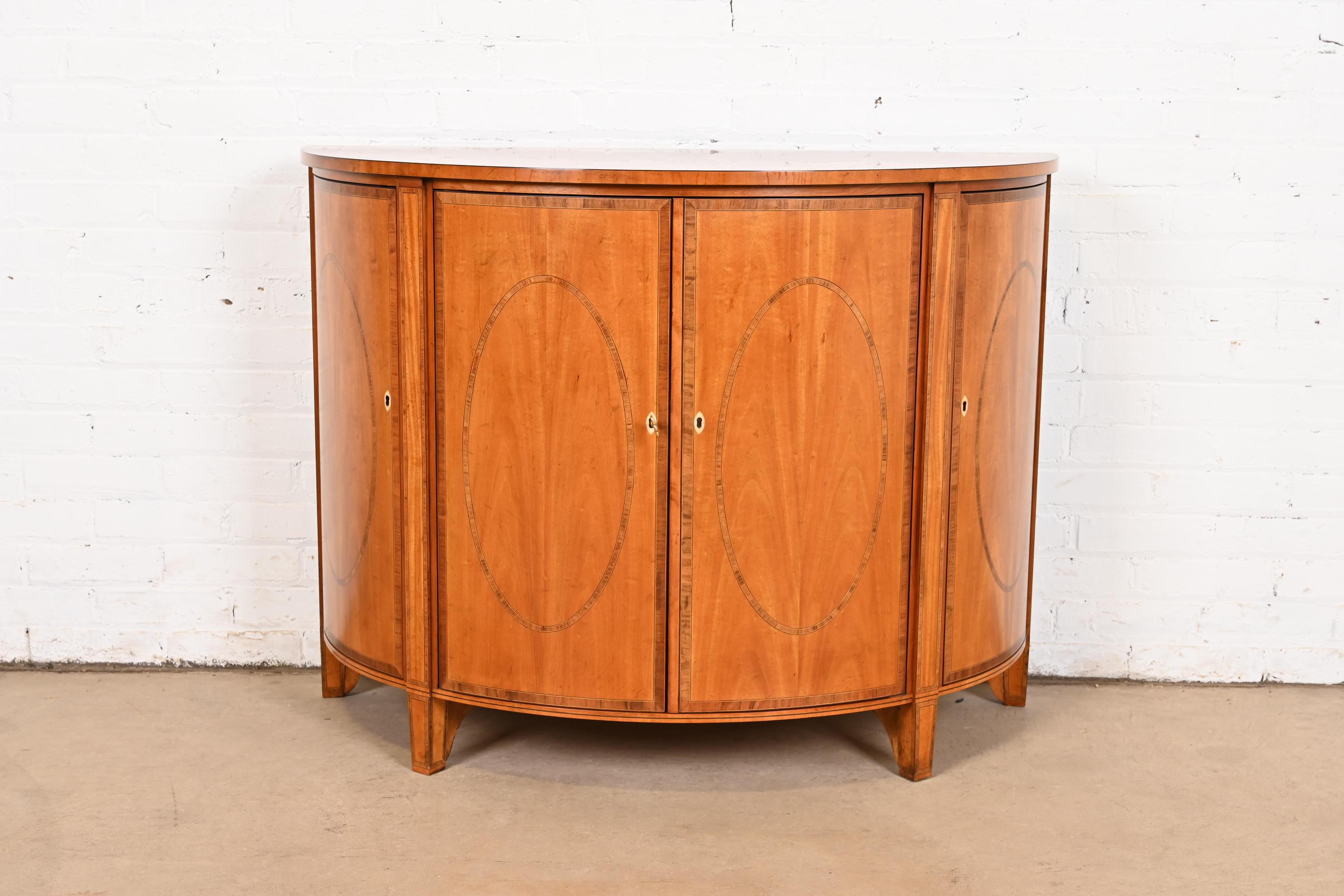 A gorgeous Federal or Hepplewhite style demilune sideboard, cabinet, or console table

By Baker Furniture, 