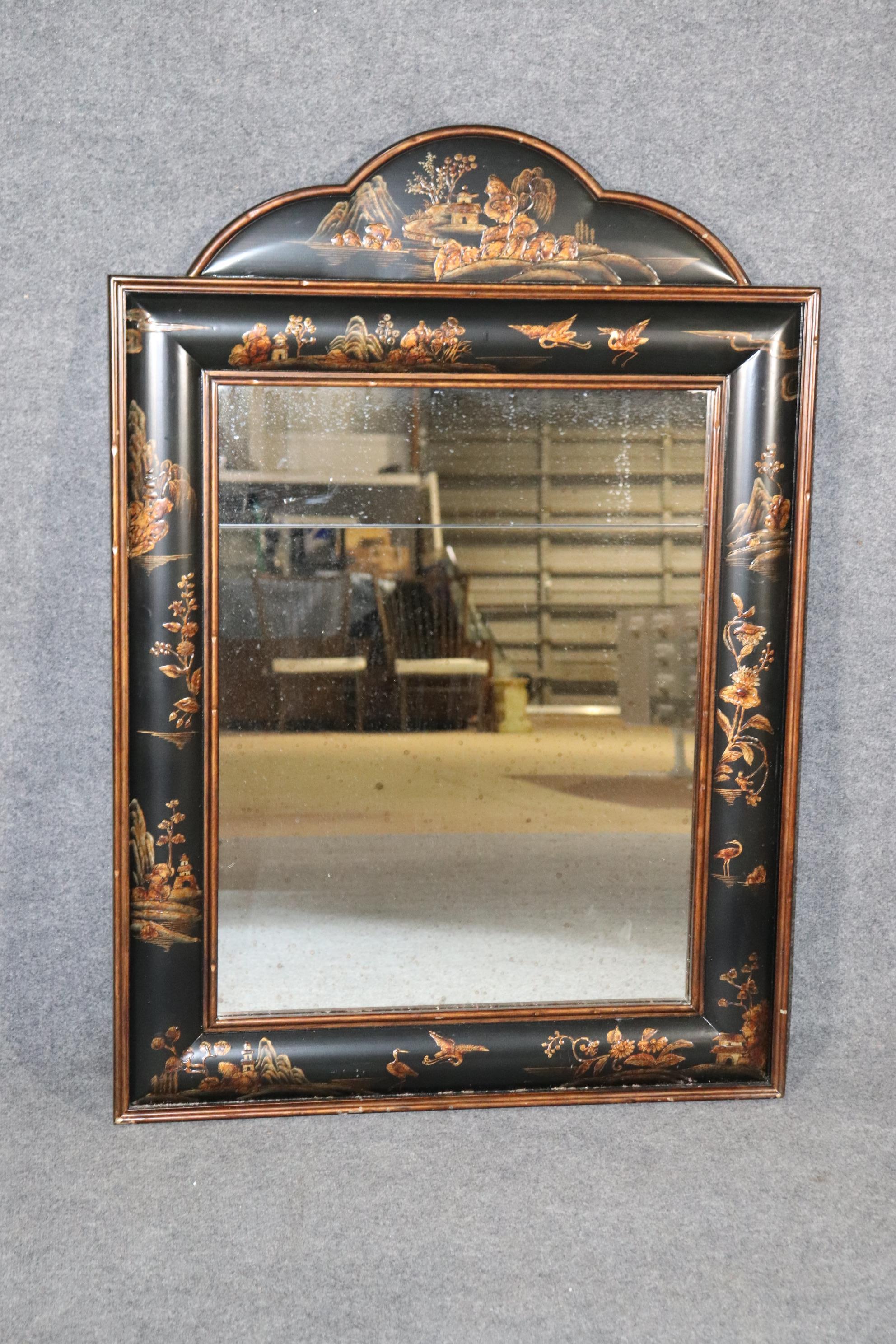 This is a gorgeous mirror done in authentic hand-painted raised chinoiserie paint decoration. The mirror is fitted with an antique aged patina glass and has two panes of glass the way the antique 18th century mirrors were often done. The mirror