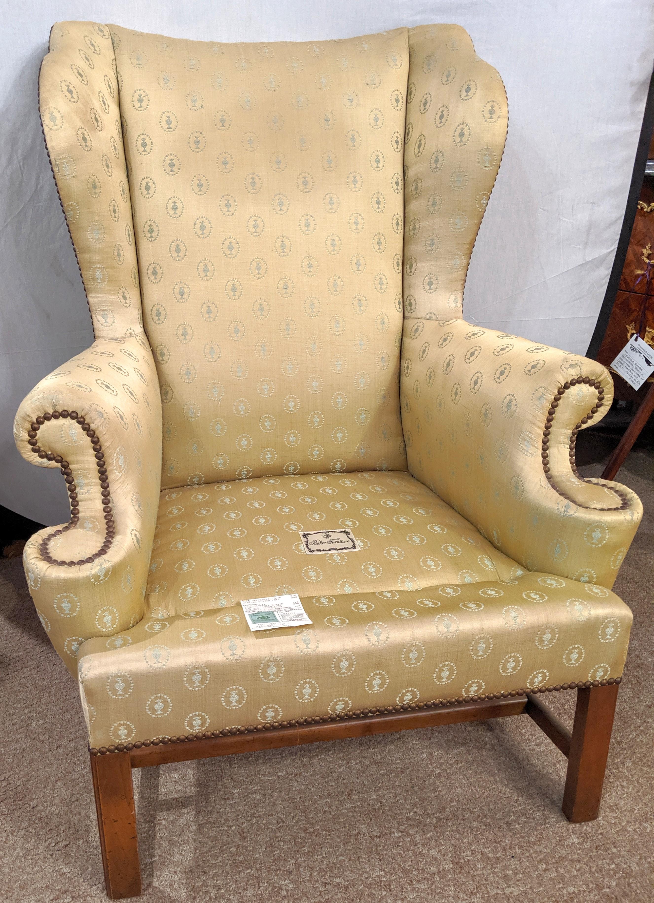 A custom quality 'Baker' Chippendale wingback chair in a fine fabric with down cushions.