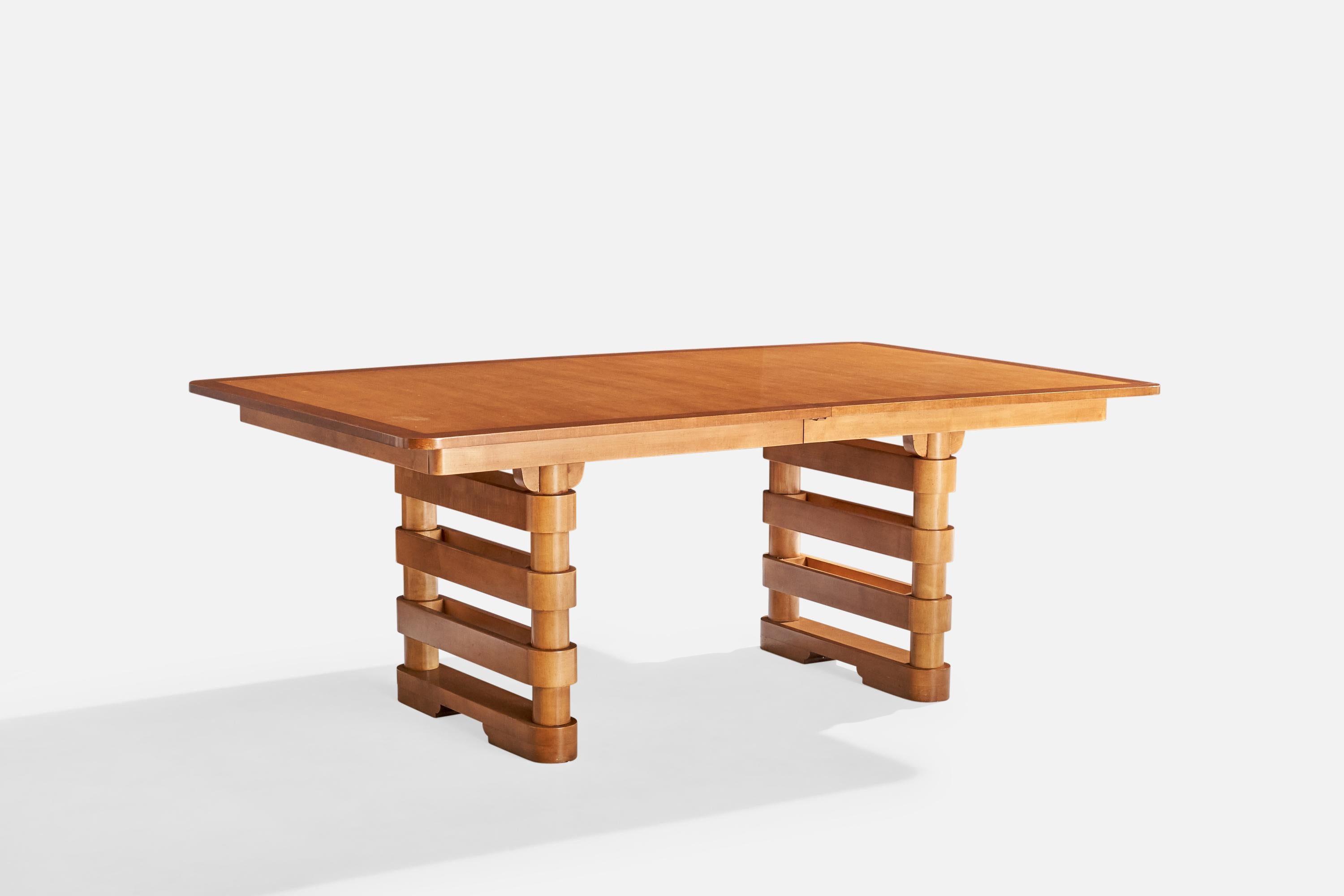 A maple and teak dining table produced by Baker Furniture, USA, c. 1950s.

Depth 96.25” with one insert, 116.25” with both