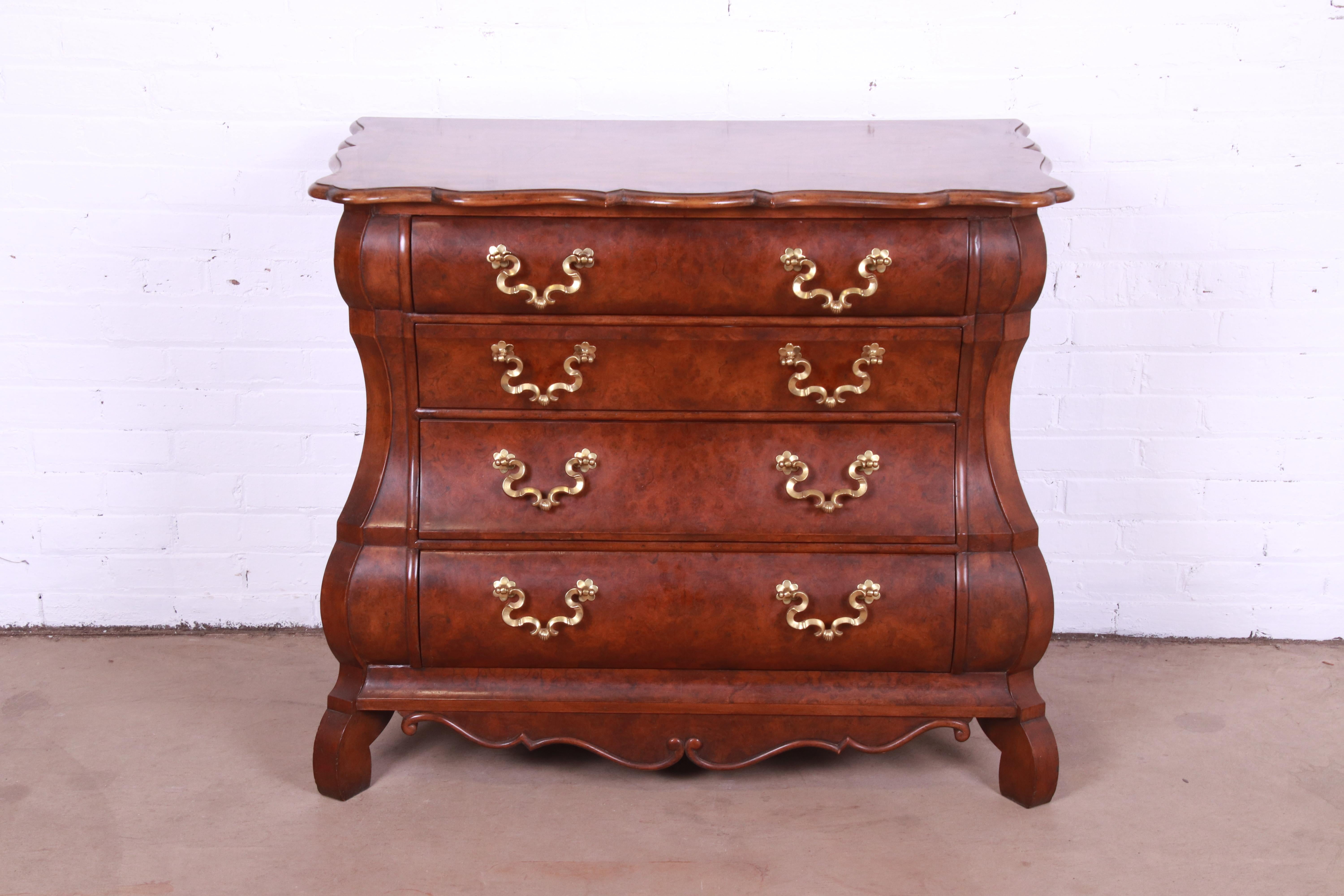 A gorgeous Dutch Louis XV style bombay chest, commode, or dresser

By Baker Furniture

USA, Circa 1980s

Burled walnut, with brass hardware.

Measures: 39