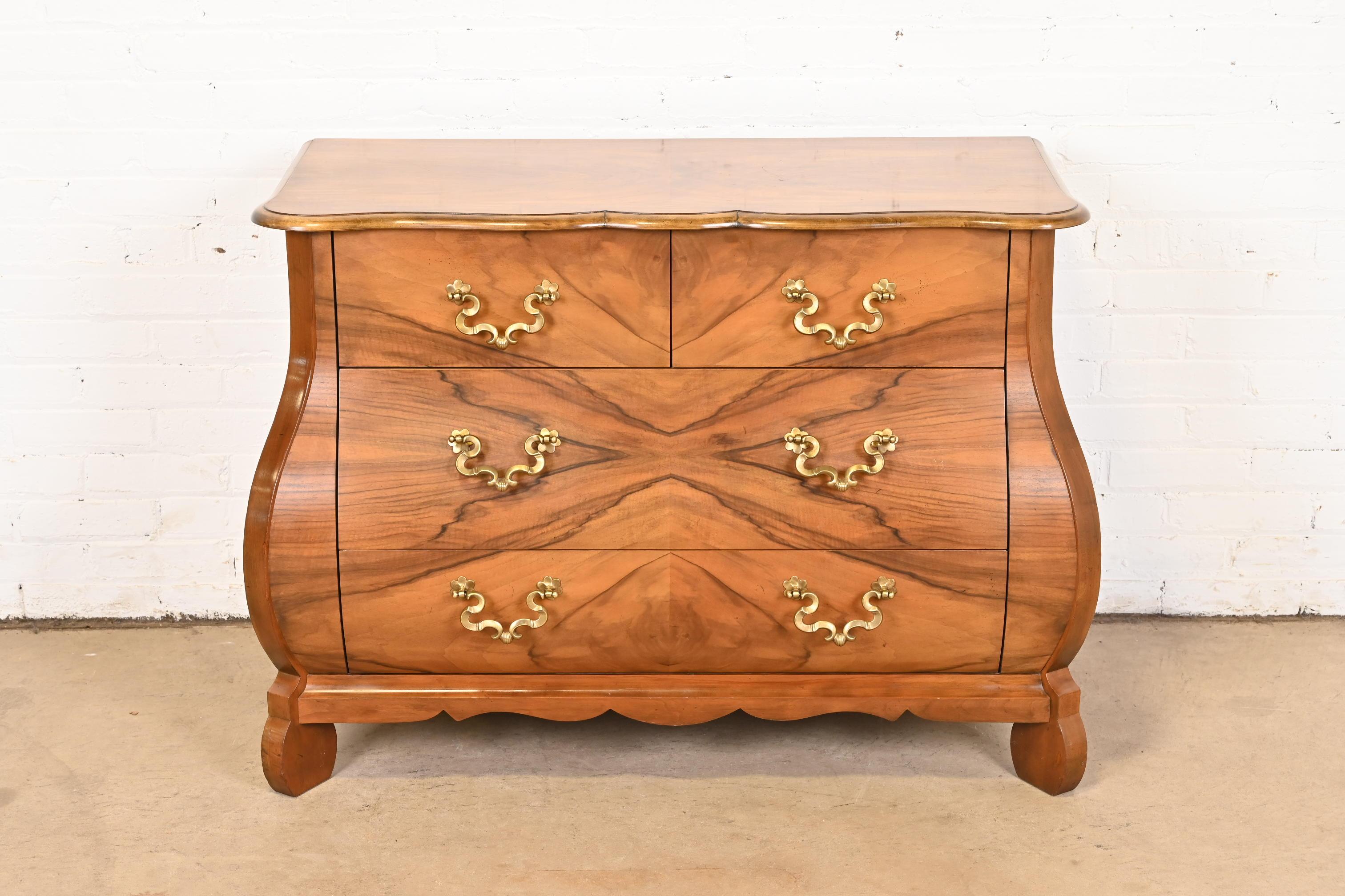 A gorgeous Dutch or French Provincial Louis XV style bombay chest, commode, or dresser

By Baker Furniture

USA, Late 20th Century

Book-matched burled walnut, with original brass hardware.

Measures: 42.5