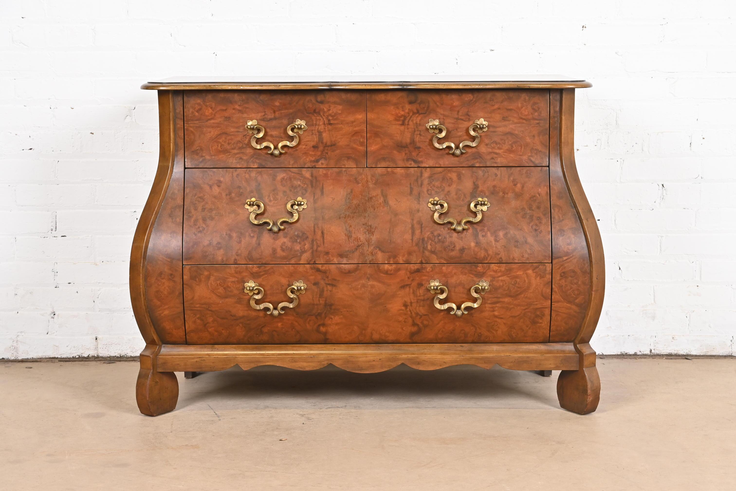 A gorgeous Dutch or French Provincial Louis XV style bombay chest, commode, or dresser

By Baker Furniture

USA, Circa 1960s

Book-matched burled walnut, with original brass hardware.

Measures: 42.25